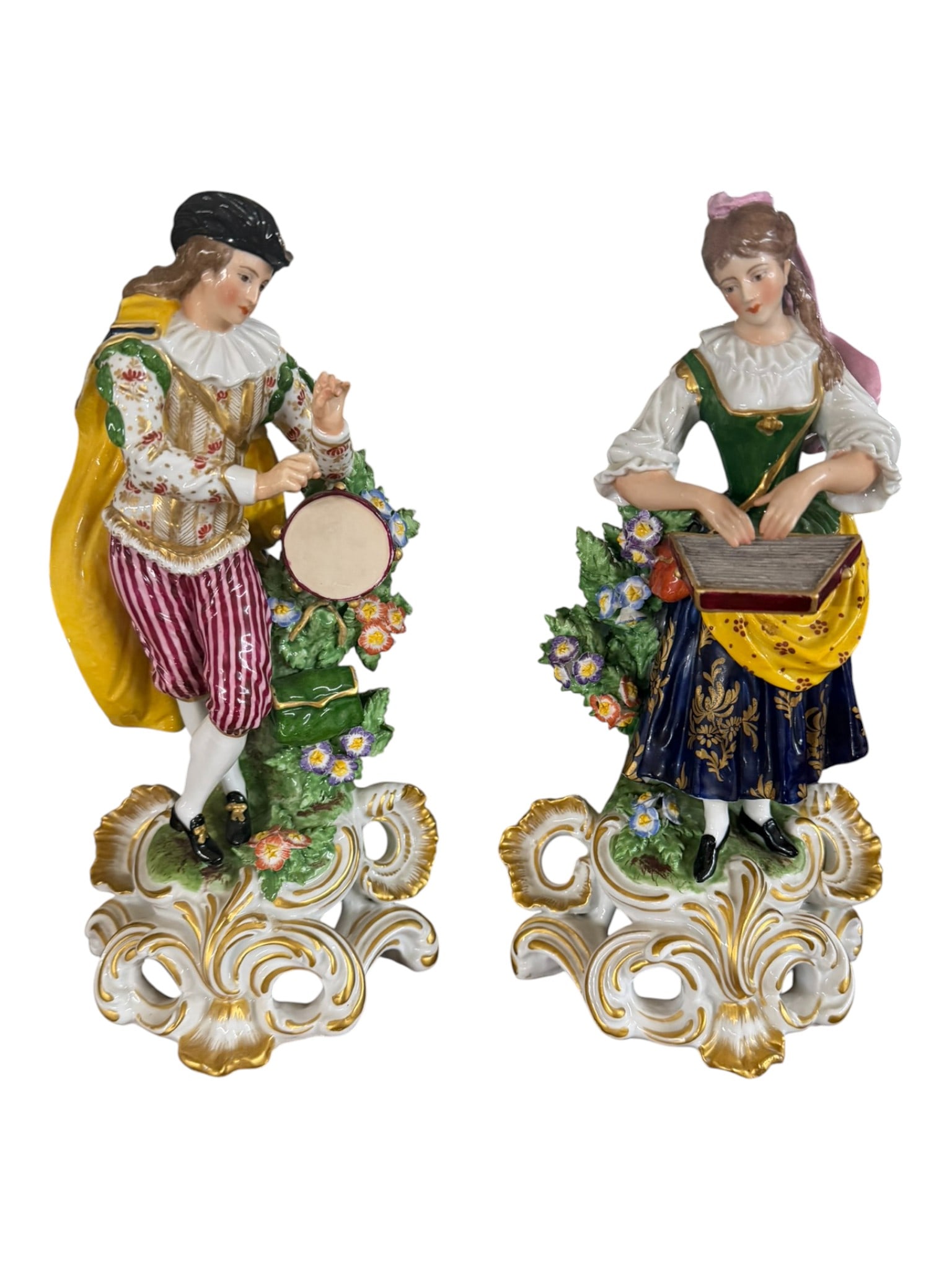 Pair of Continental Porcelain Musician Figures, Late 19th/Early 20th Century: A colorful pair of Continental porcelain musician figures, each modeled in high relief and richly hand-painted in vivid enamels with gilt flourishes. The male figure stands poised with a tabor drum, d