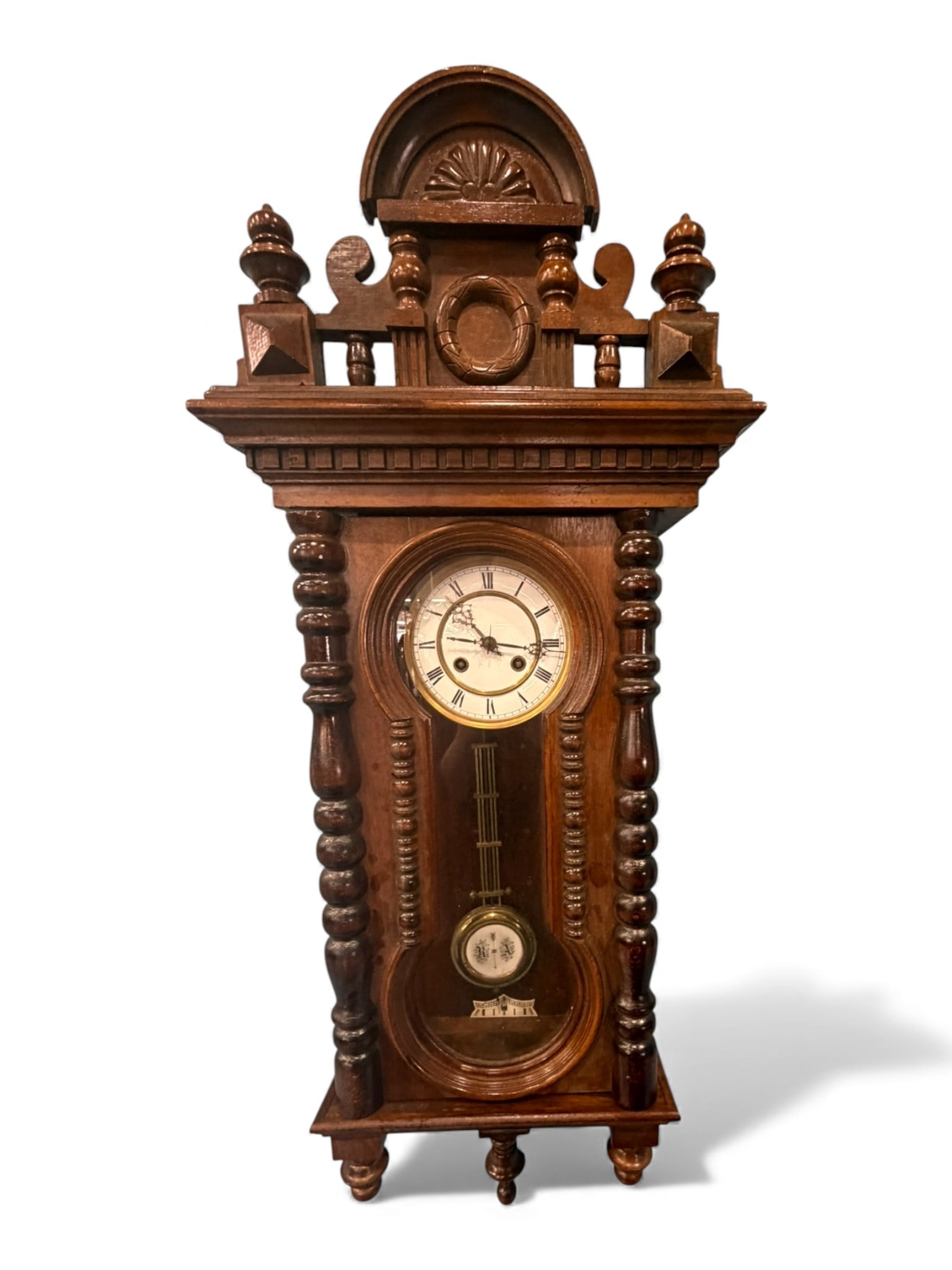 Walnut Vienna Regulator Wall Clock, Late 19th Century: A Continental walnut Vienna regulator wall clock, late 19th century, with a boldly architectural crest featuring turned finials, pierced scrollwork, and an arched pediment carved with a radiating shel