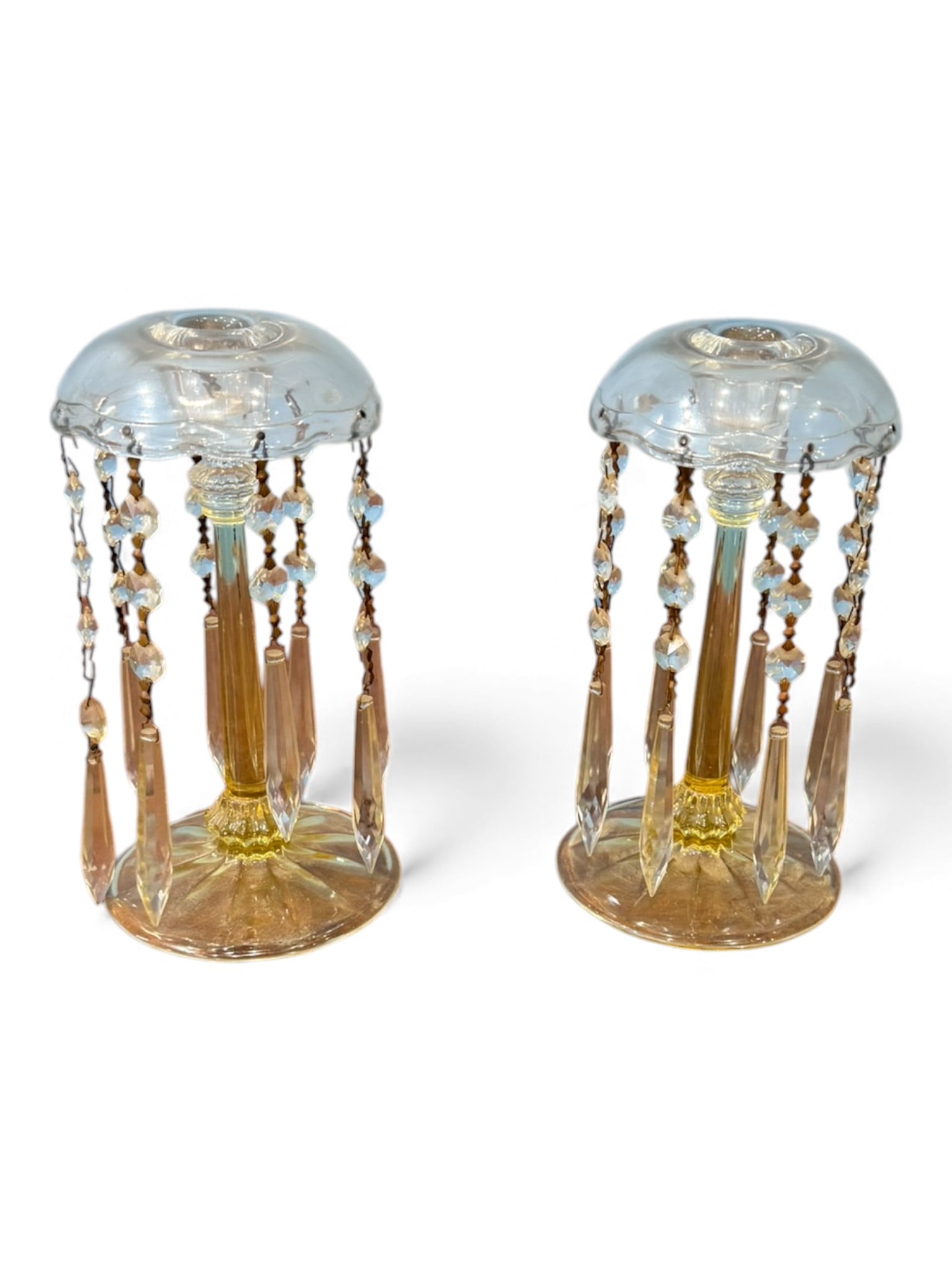 Pair of Victorian Pressed Glass Luster Candlesticks, Late 19th Century: Graceful pair of late Victorian pressed glass luster candlesticks, each fitted with a domed molded drip pan hung with graduated faceted prism drops suspended from original wire chains. The candlestick