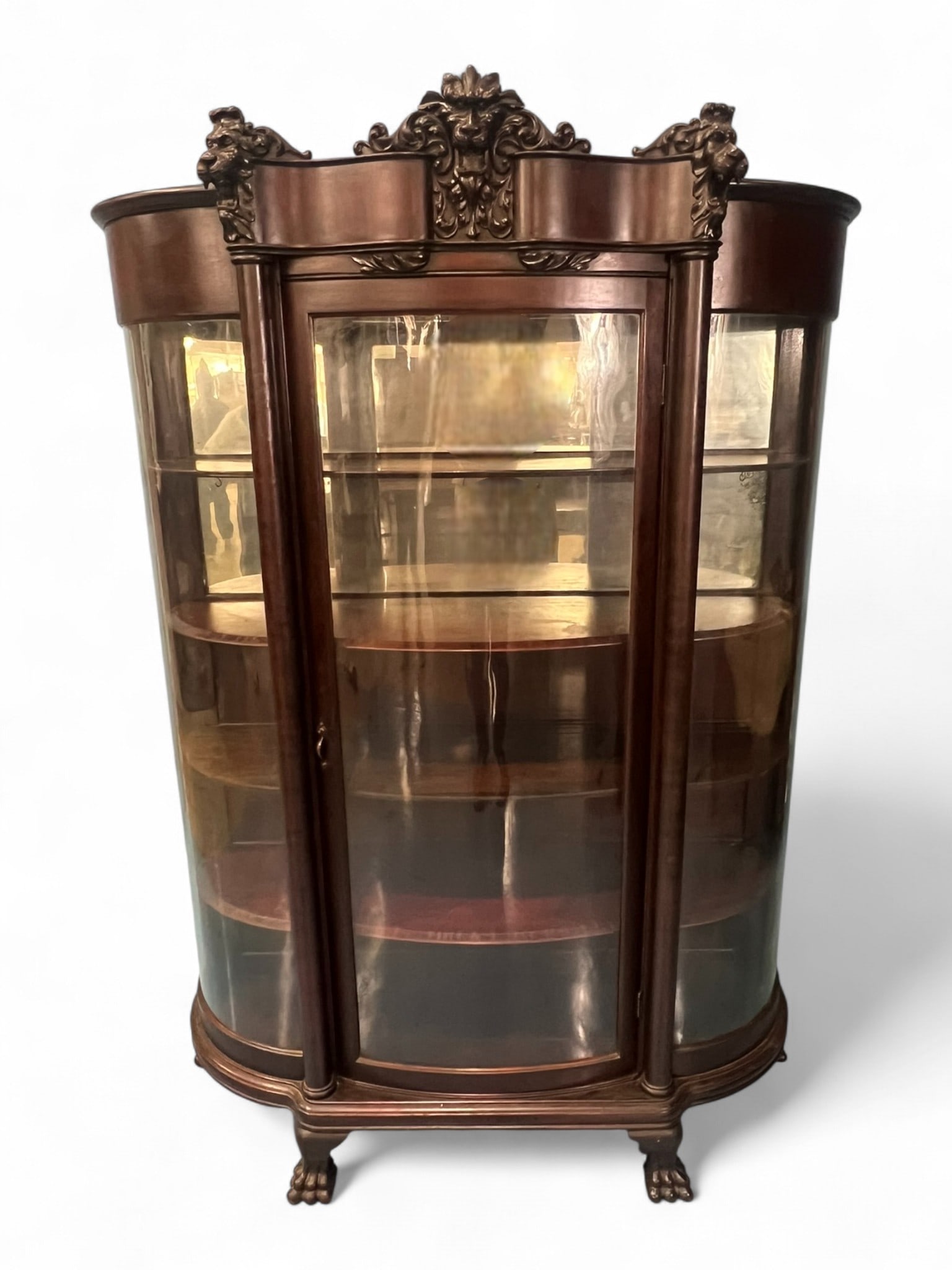 Carved Mahogany Curved Glass China Cabinet, Attr. To R.J. Horner, Circa 1900: Magnificent carved mahogany curved-glass china cabinet, attributed to R.J. Horner & Co., New York, circa 1900. The cabinet features an elaborate foliate and grotesque mask crest flanked by boldly carv