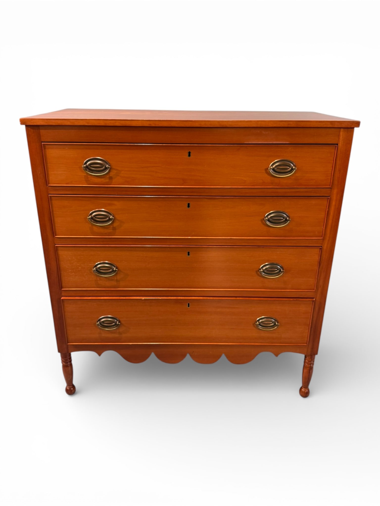 Federal Cherry Chest of Drawers: A handsome American Federal cherry chest of drawers, early 19th century, of refined and well-proportioned form. The case features four graduated drawers with cockbeaded edges, each fitted with oval
