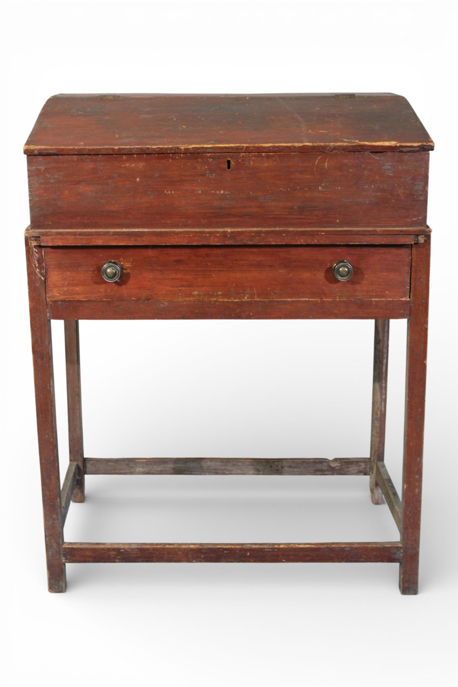 American Primitive Schoolmaster’s Lift-Top Desk, Pennsylvania: Antique Pennsylvania-origin primitive schoolmaster’s desk featuring a slant-front lift-top writing lid with original dovetail joinery, over a single long drawer fitted with two turned wooden pulls.