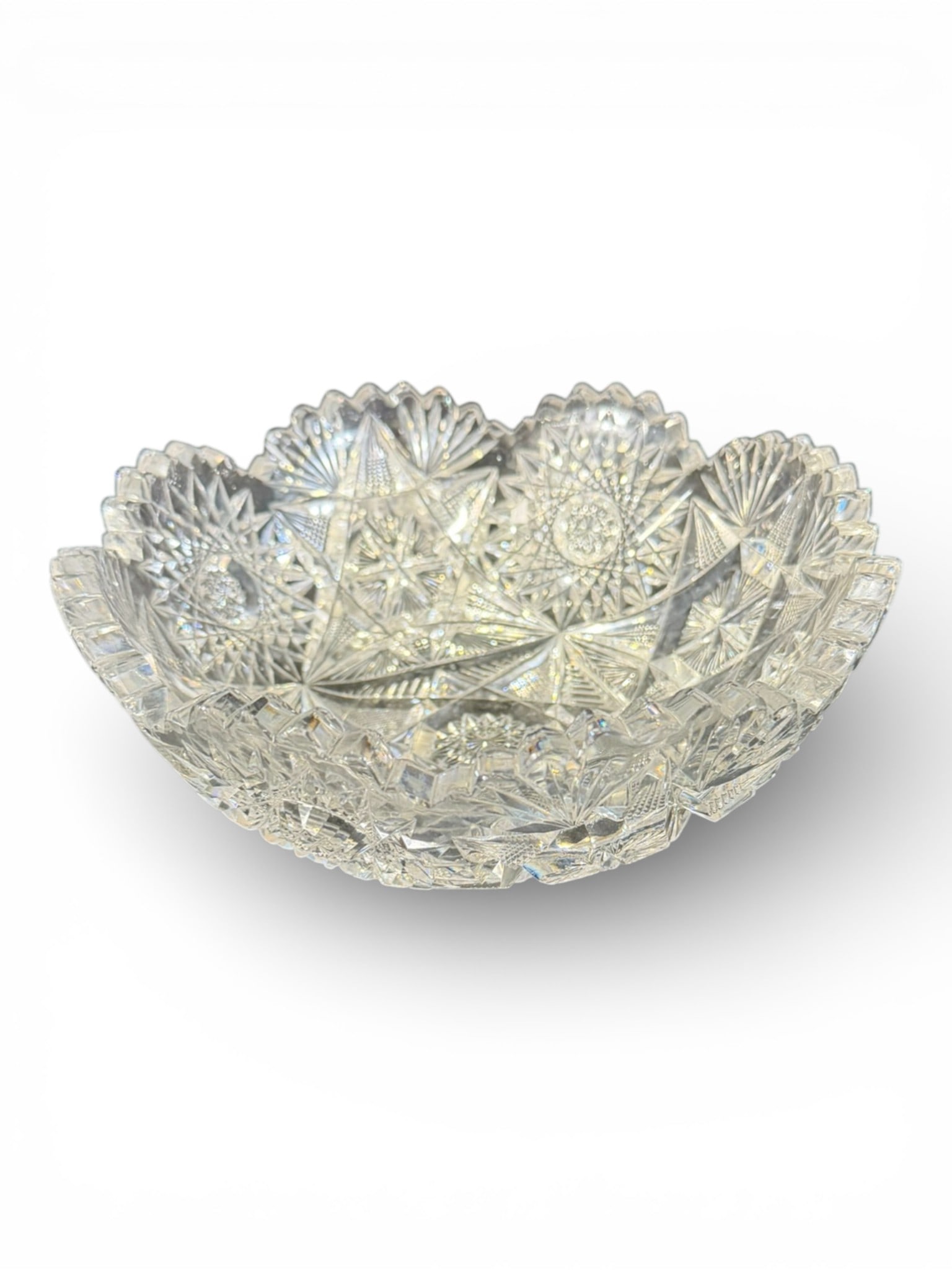 American Brilliant Cut Glass Bowl, Early 20th Century: A finely cut American Brilliant Period glass bowl executed in heavy clear crystal with exceptional precision and brilliance. The interior is richly decorated with radiating starbursts, hobstars, and g