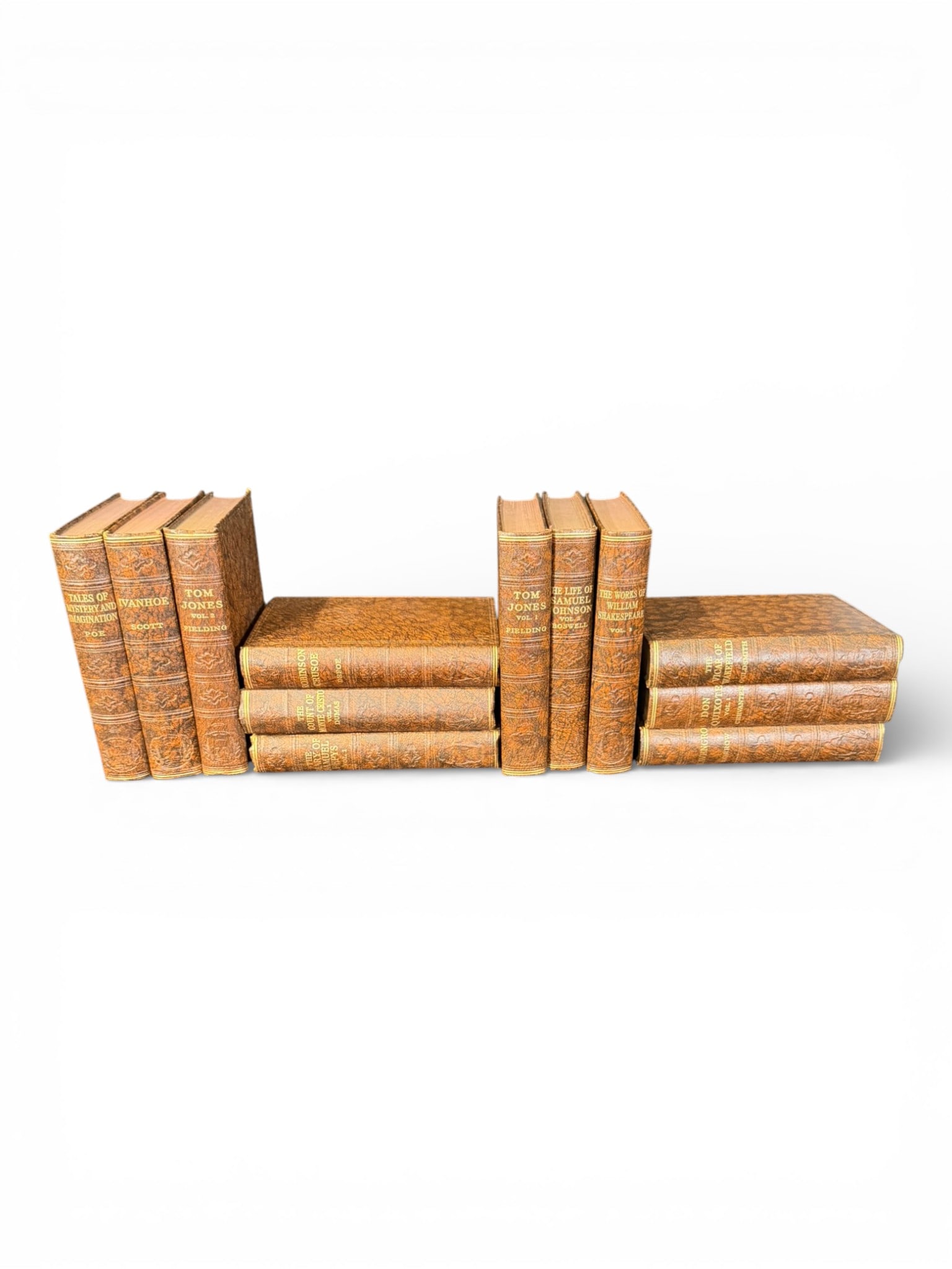 Set of Twelve (12) English Leather-Bound Novels: A set of twelve (12) decorative English novels, presented in brown leather-style bindings with gilt-lettered spines and classical ornamentation. This collection features an attractive assortment of