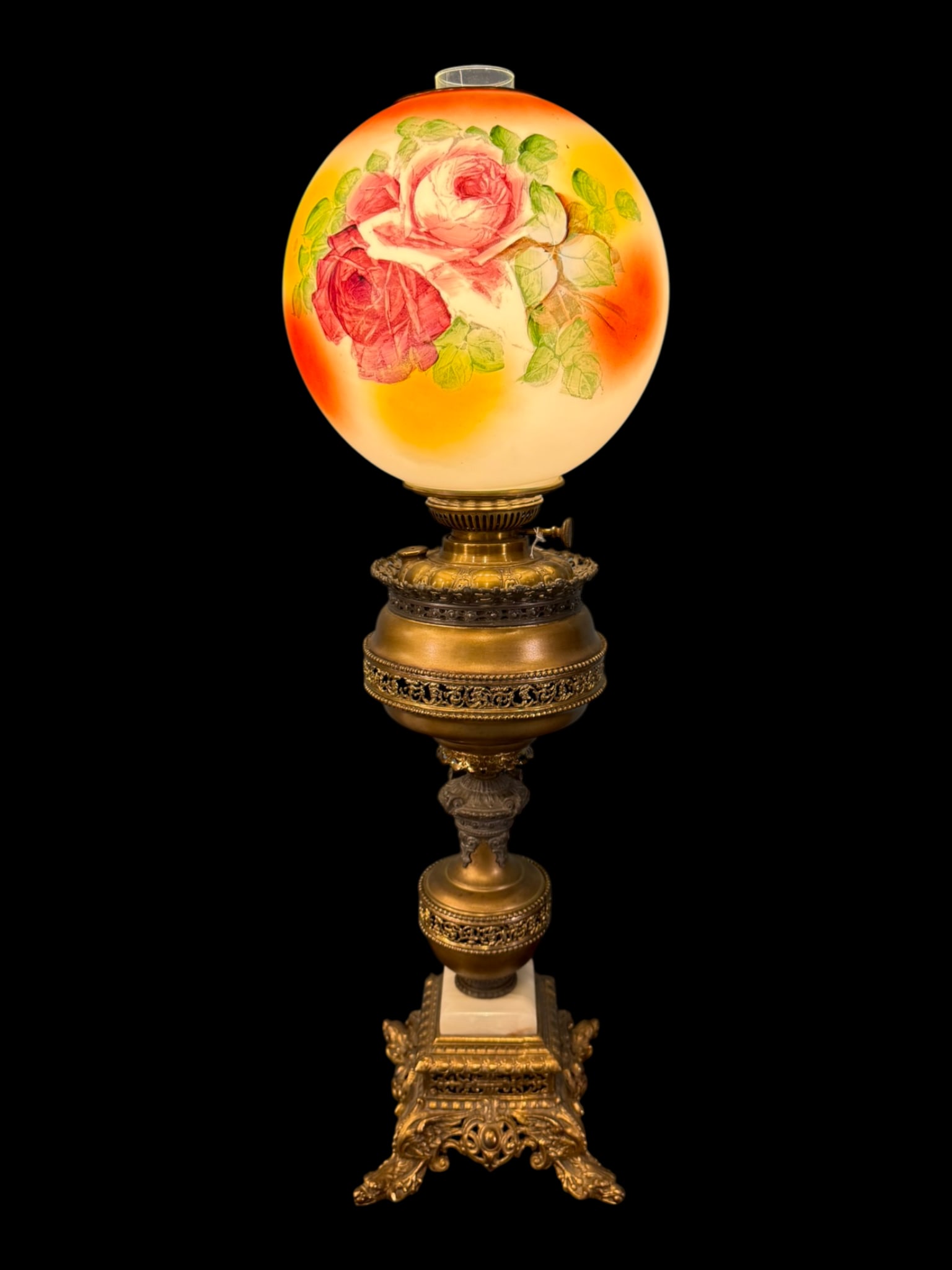 Victorian Brass and Onyx Banquet Lamp, 19th Century: A handsome Victorian banquet lamp constructed of cast and turned brass with an onyx-mounted base, fitted with a hand-painted satin glass globe decorated with roses and foliate sprays against a warm