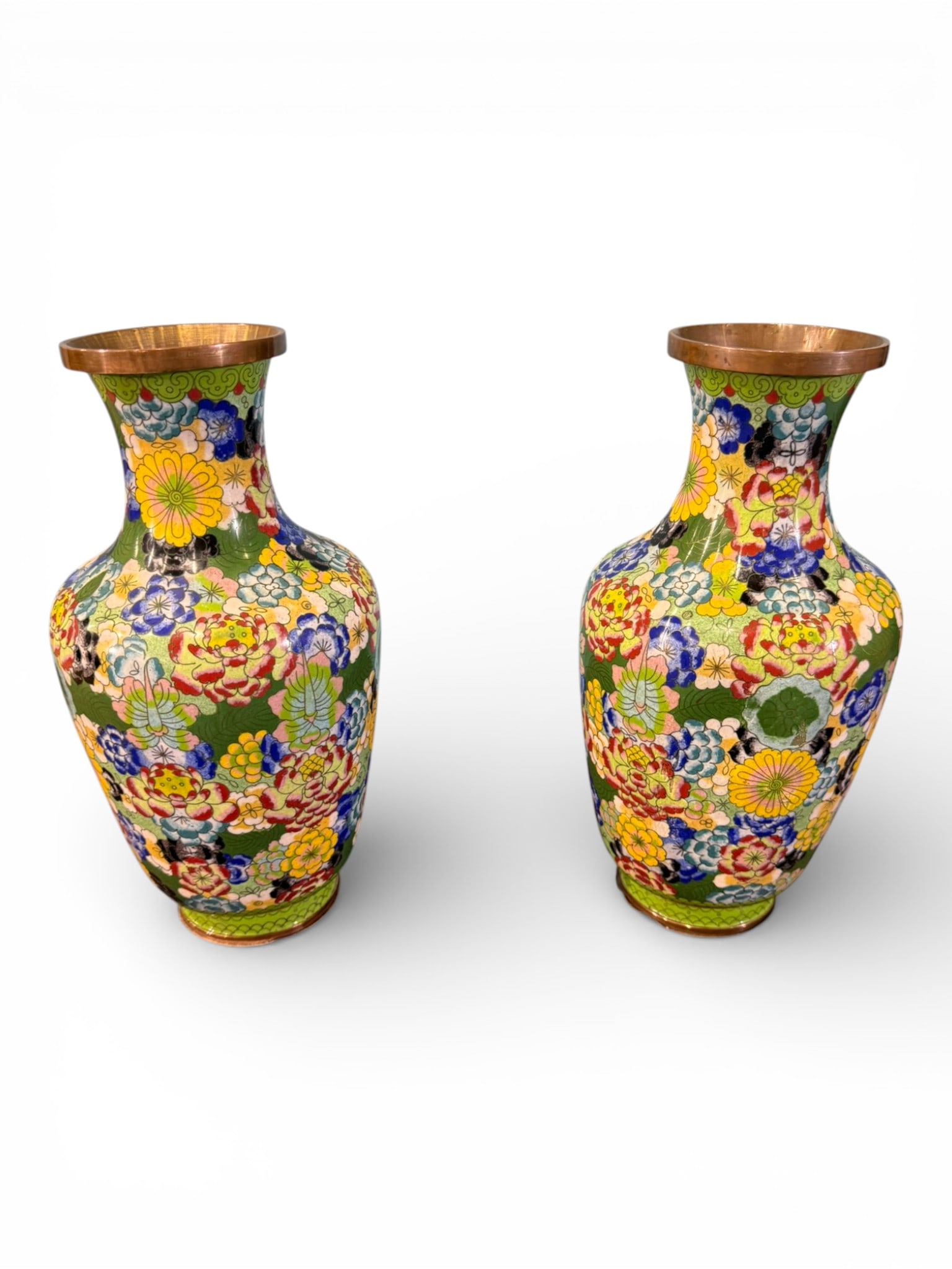 Pair of Chinese Cloisonné Enamel Vases with Floral Decoration: A decorative pair of Chinese cloisonné enamel vases of baluster form, each finely decorated with an allover floral motif against a rich green ground. The surfaces feature densely arranged