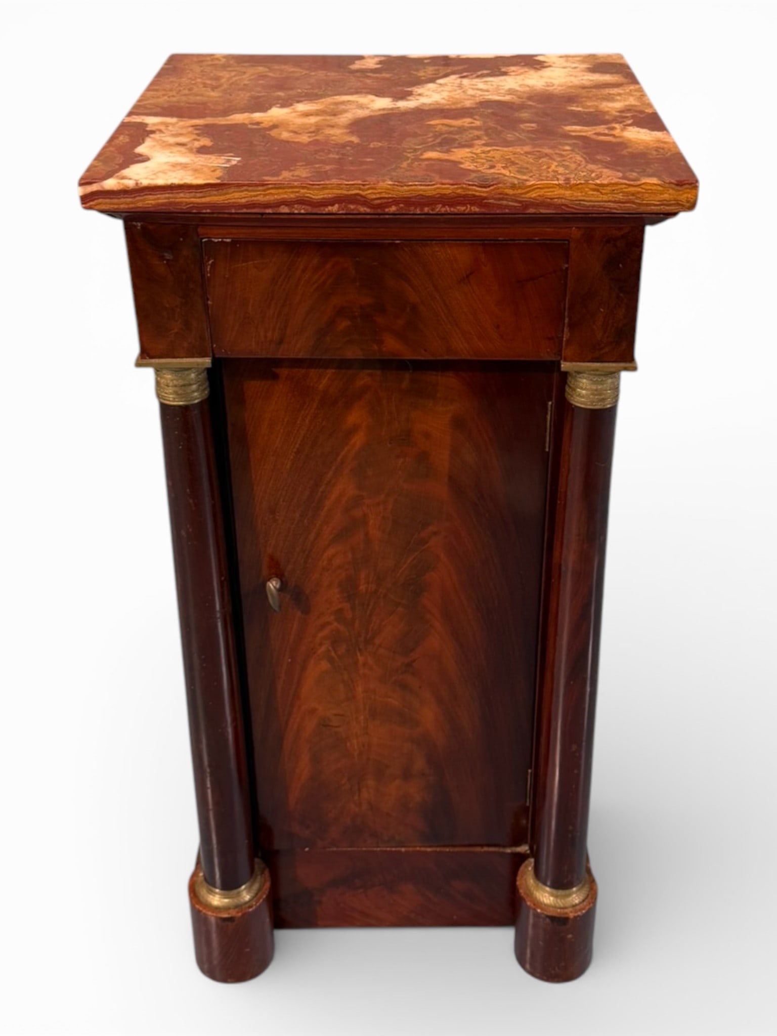 French Empire Rosewood Marble-Top Petite Commode, 19th Century: Elegant French Empire petite commode, crafted in richly figured rosewood veneer and designed in the form of a narrow cabinet with rounded columnar supports mounted with gilt-bronze style collars and c