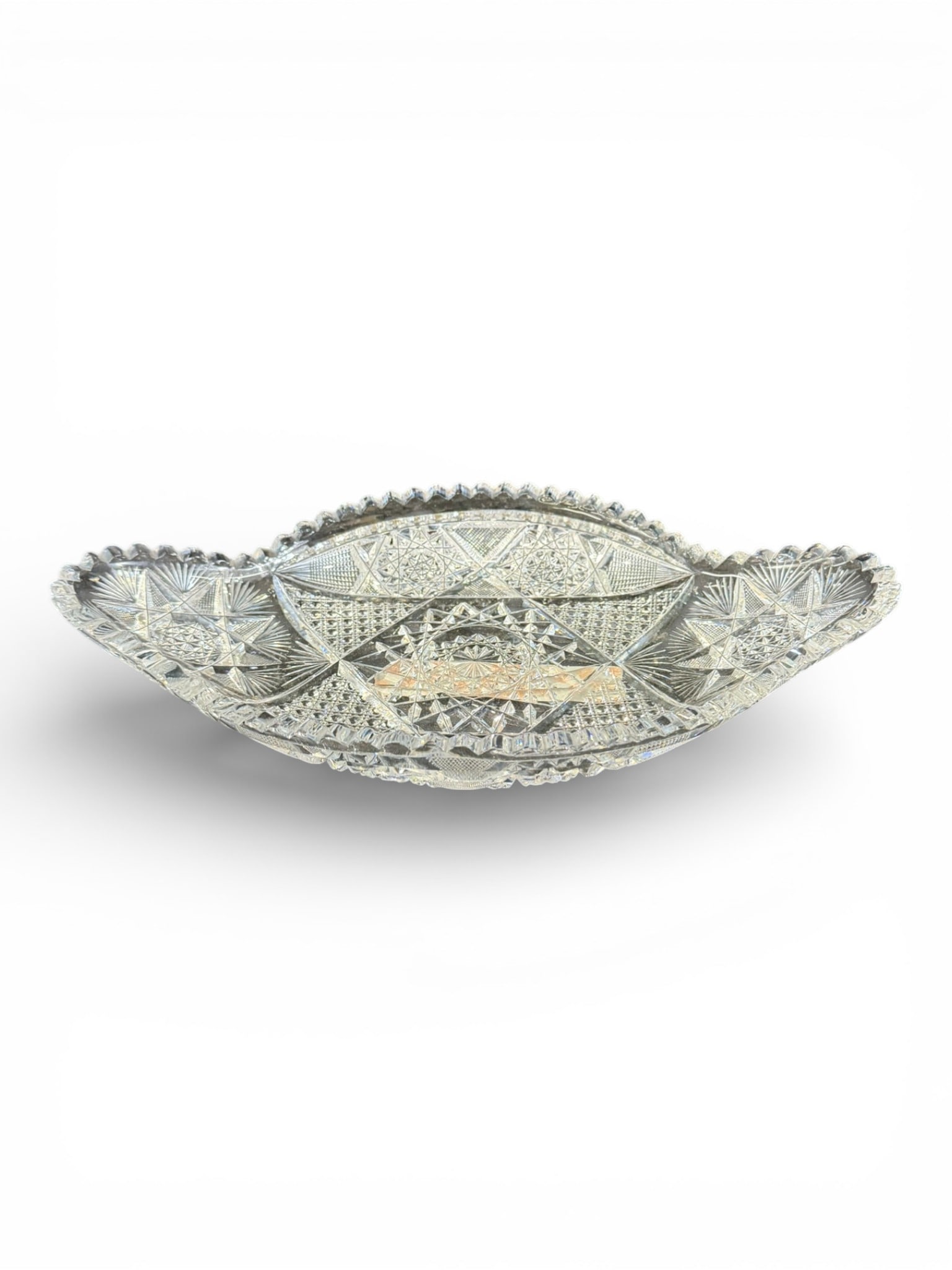 American Brilliant Cut Glass Ice Cream Tray: Finely executed American Brilliant Period cut glass ice cream tray of elongated oval form with flared, pointed ends and scalloped rim. The tray is richly decorated in an intricate geometric pattern fe