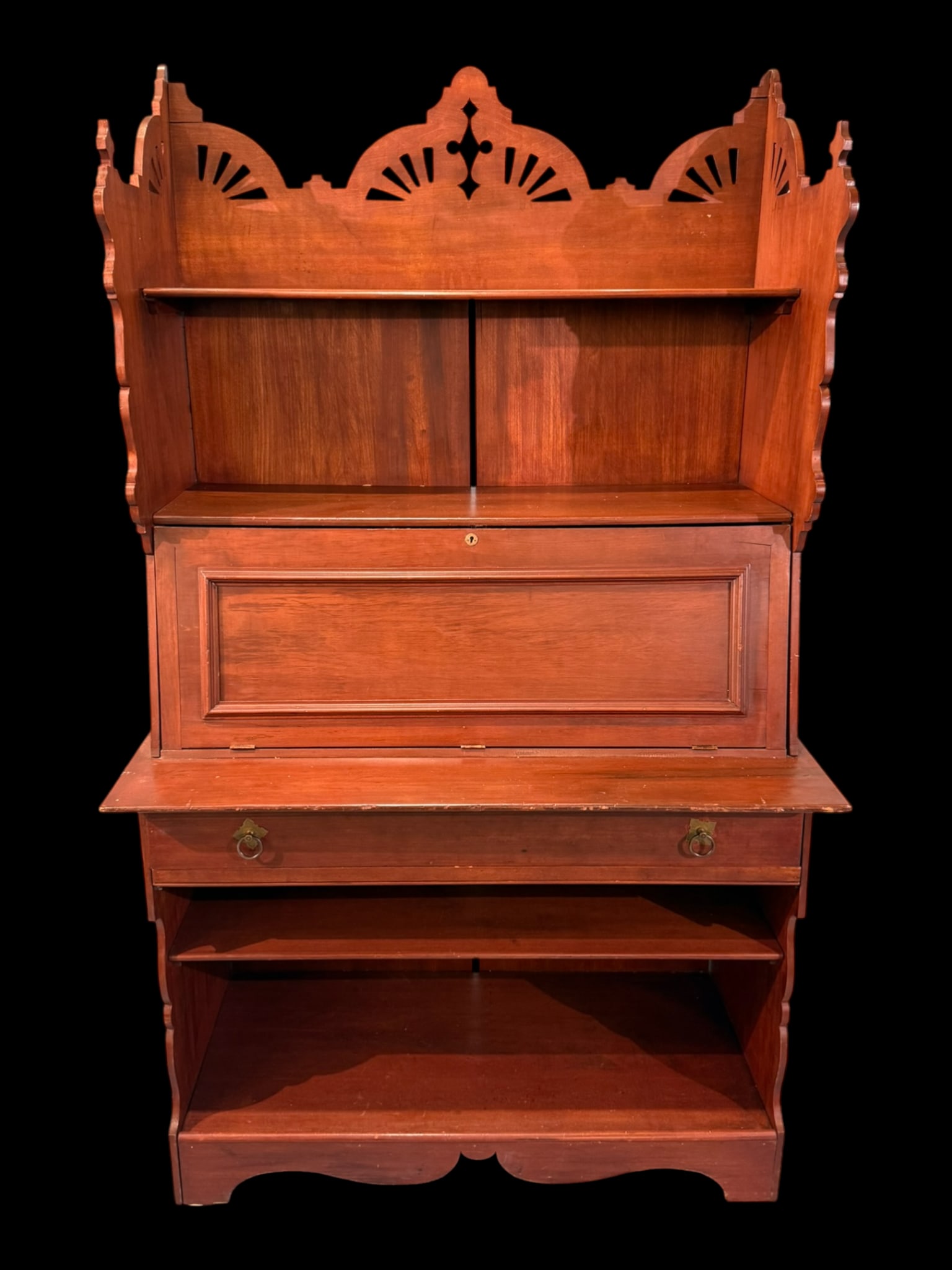 Eastlake Revival Secretary Desk with Hutch, Late 19th Century: A handsome Eastlake Revival secretary desk with integral hutch, crafted in richly grained hardwood and featuring a stepped and pierced crest rail with sunburst and quatrefoil cutwork, flanked by