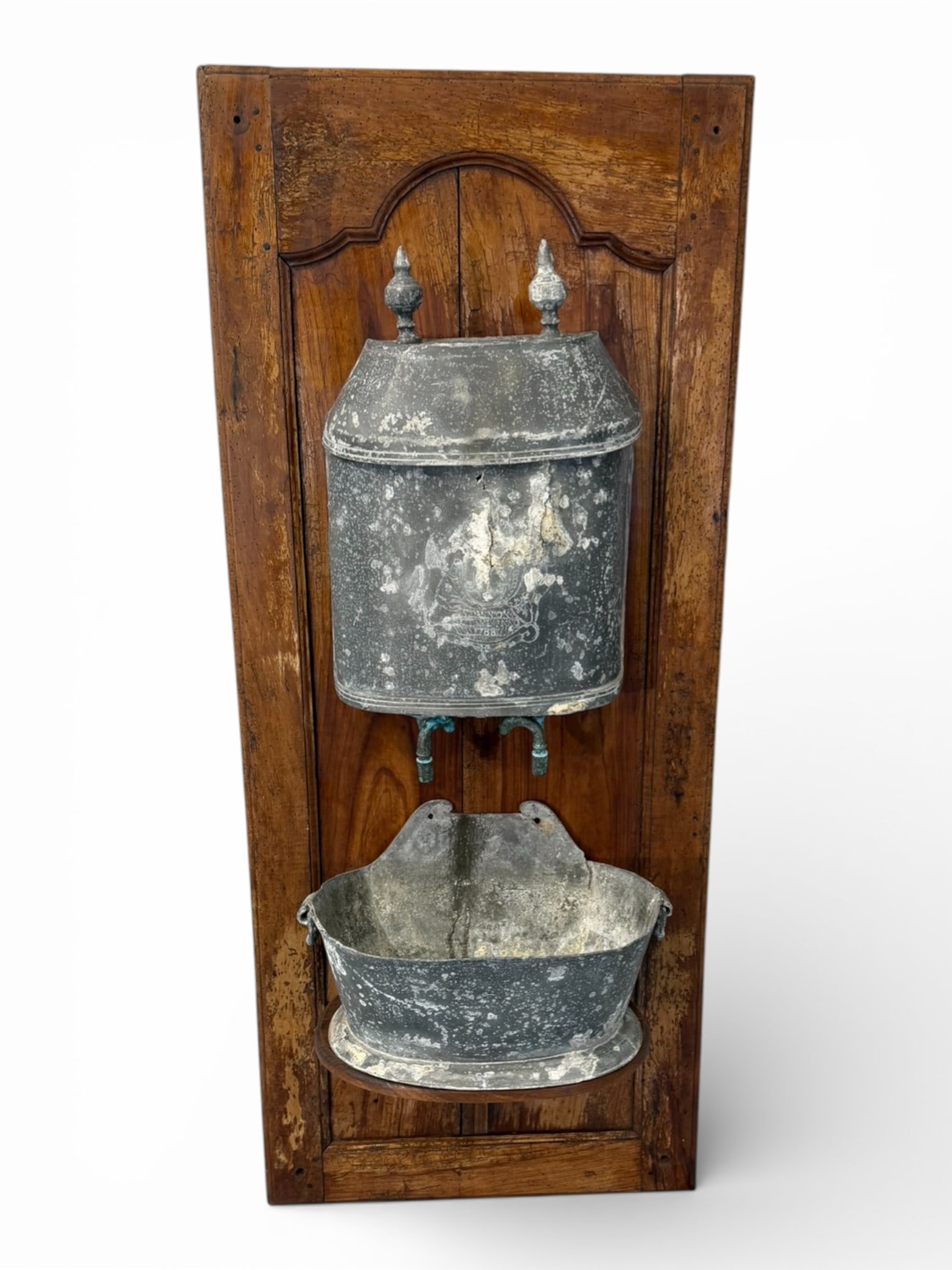 19th Century French Provincial Lavabo with Lead Reservoir: Charming and highly decorative 19th century French Provincial wall-mounted lavabo, retaining its original lead-covered water reservoir with domed lid and twin finial mounts above a shaped basin. The e