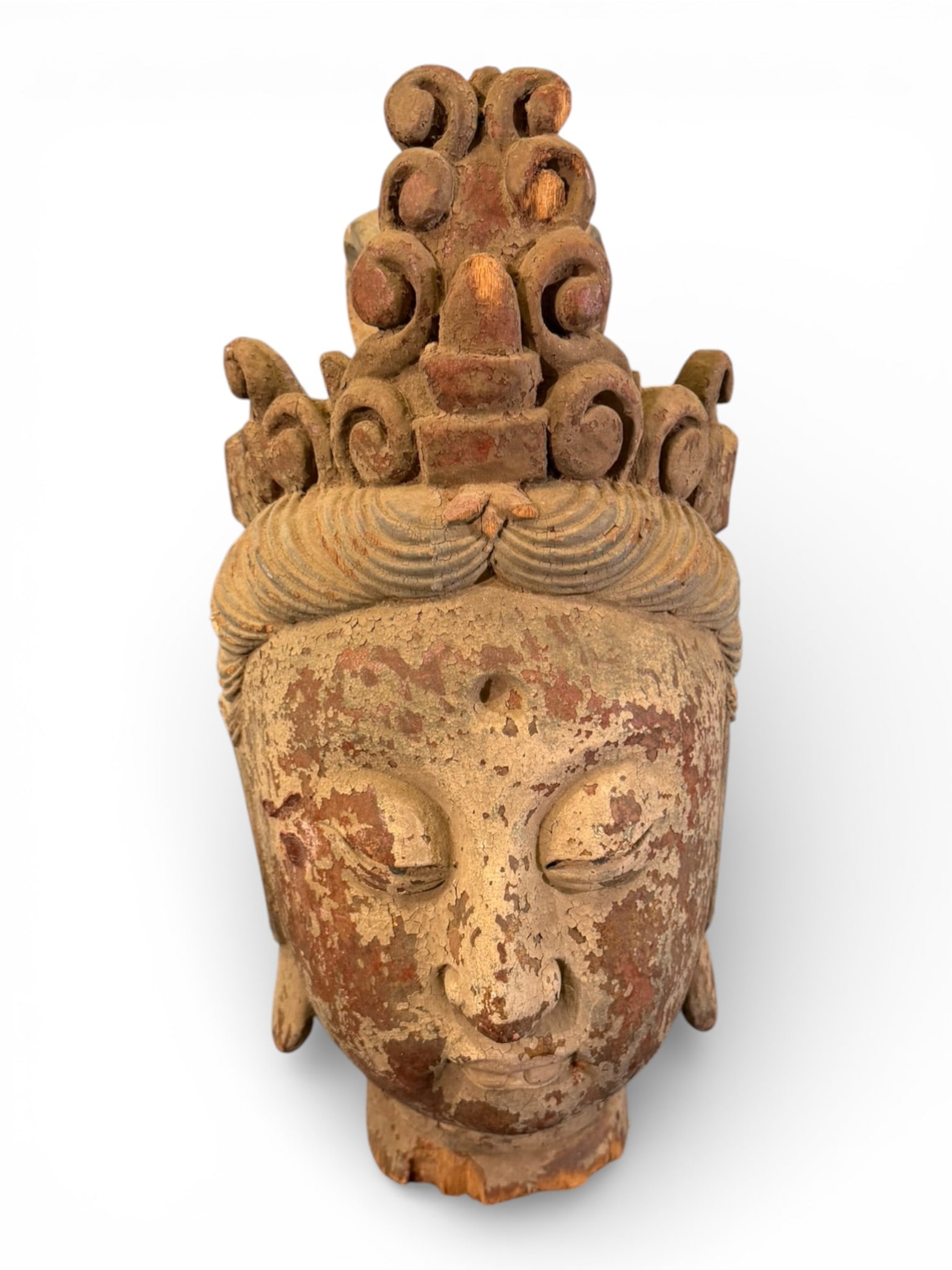 Chinese Carved Wood Bodhisattva Head: Impressive Chinese carved wood head of a bodhisattva, likely representing Guanyin, depicted with serene downcast eyes, softly modeled features, and an elaborate tiered headdress composed of scrolling