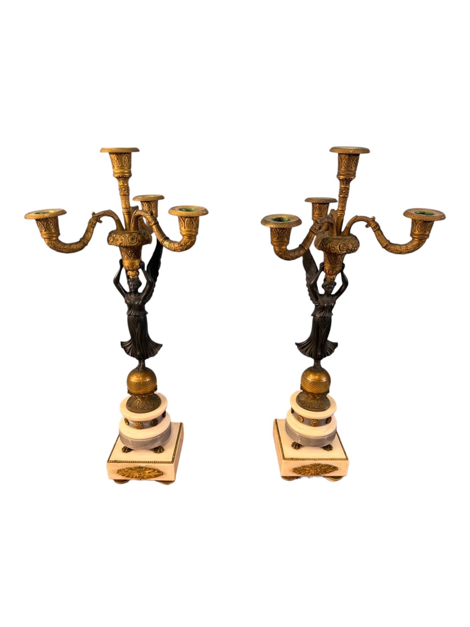 Pair of French Empire Style Figural Five-Light Candelabra: Elegant pair of French Empire style five-light candelabra, each centered by a classical winged female figure supporting a gilt bronze foliate chandelier-form superstructure. The scrolling candle arms