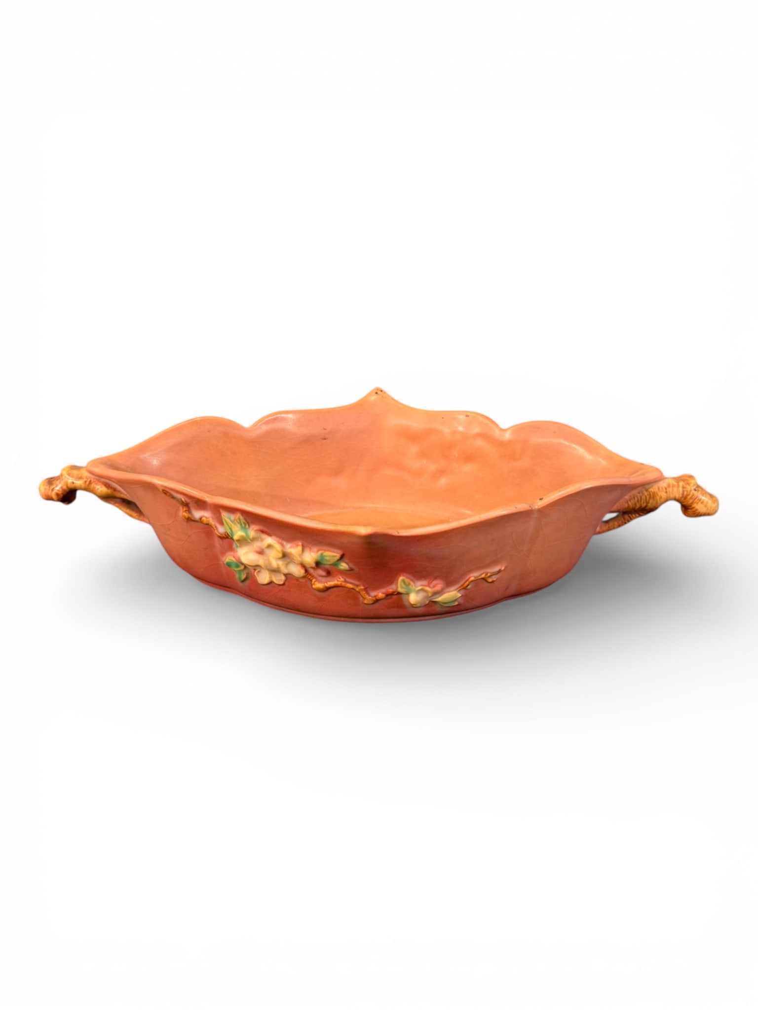 Roseville Pottery “Magnolia” Console Bowl, Shape 331-12: Fine Roseville Pottery console bowl in the Magnolia pattern, featuring a softly scalloped rim and low oval form accented with applied floral sprays of cream blossoms with green leaves on a warm coral