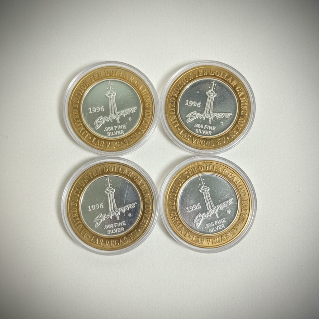 Four Stratosphere Las Vegas Silver Strike Gaming Tokens: Silver Strike tokens issued by the Stratosphere Hotel & Casino, now known as The STRAT featuring .999 fine silver centers
