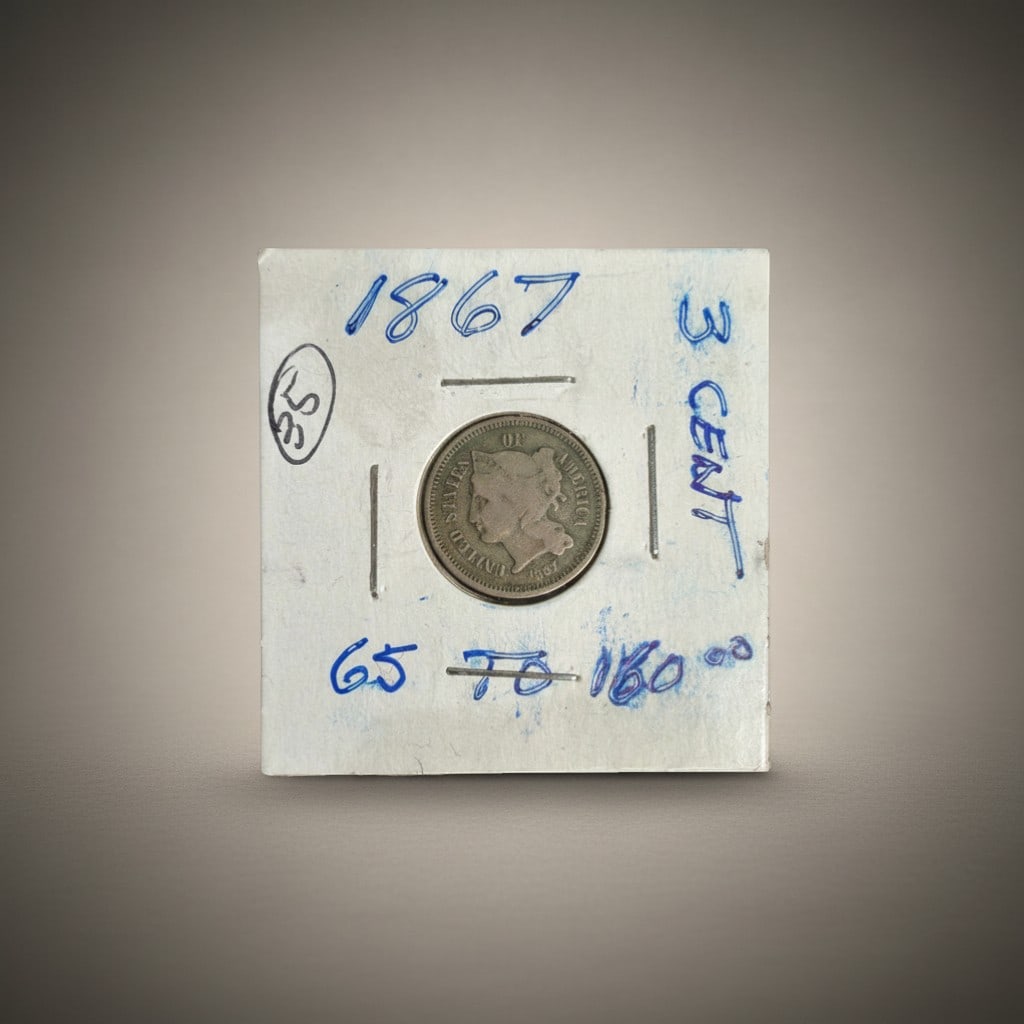 1867 Three-Cent Nickel, United States: United States three-cent nickel coin dated 1867, featuring the Liberty head obverse with coronet inscribed LIBERTY and the Roman numeral III within a wreath on the reverse. The three-cent nickel serie