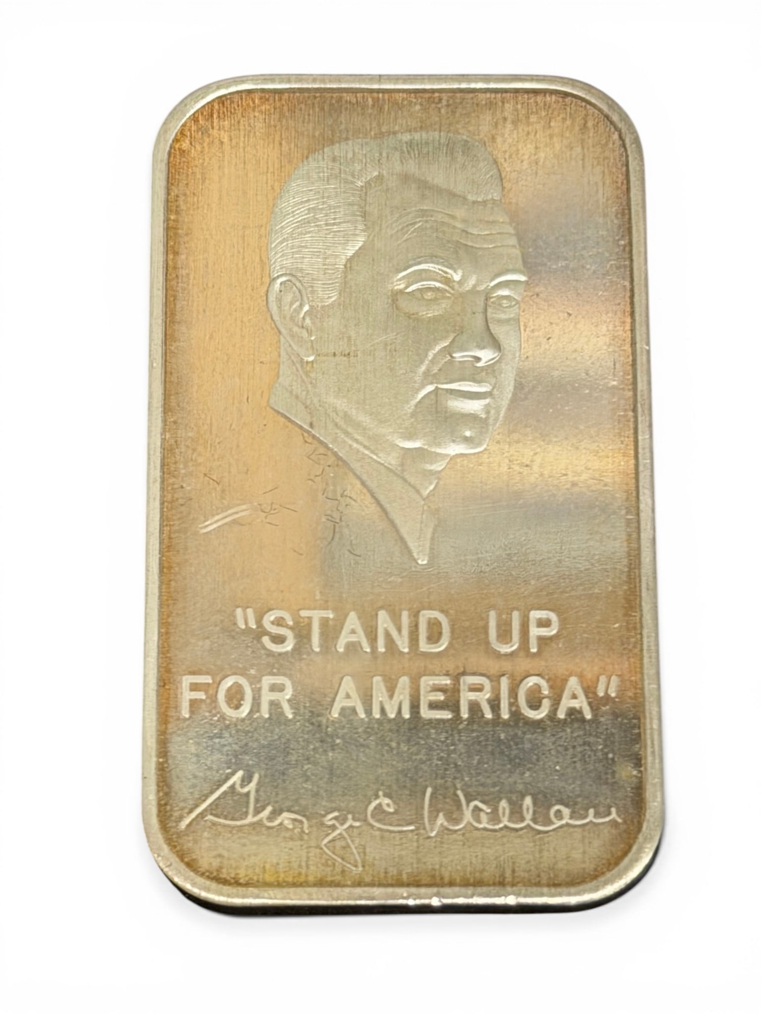 George C. Wallace Commemorative Silver Bar – World Wide Coin Investments, 1 Troy oz .999 Fine: Rectangular silver bullion bar issued by World Wide Coin Investments, Ltd., struck in one troy ounce of .999 fine silver. Obverse features inscription “George C. Wallace, Governor of Alabama”