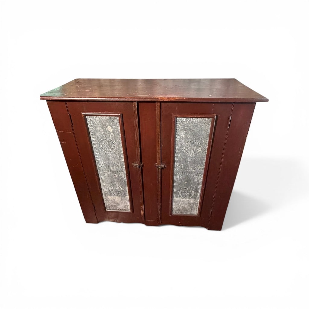 American Pie Safe with Punched Tin Panels, 19th Century: A 19th century American pie safe in a warm reddish-brown surface, featuring a rectangular case fitted with two central hinged doors inset with punched tin panels displaying traditional geometric and