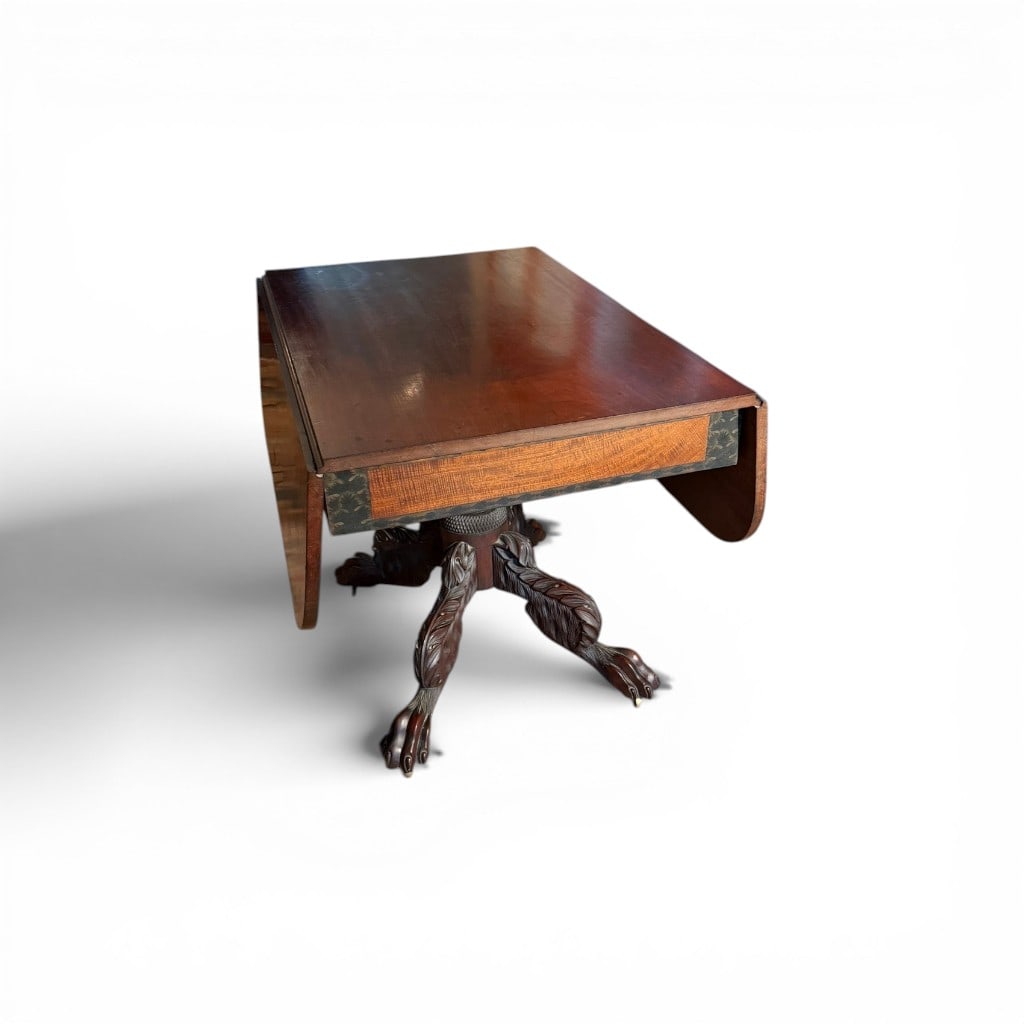 American Classical Mahogany Drop-Leaf Table, NY, mid-19th century: A finely crafted American Classical drop-leaf table, likely New York, executed in richly figured mahogany. The rectangular top opens to a generous oval form, supported by hinged leaves and a robust