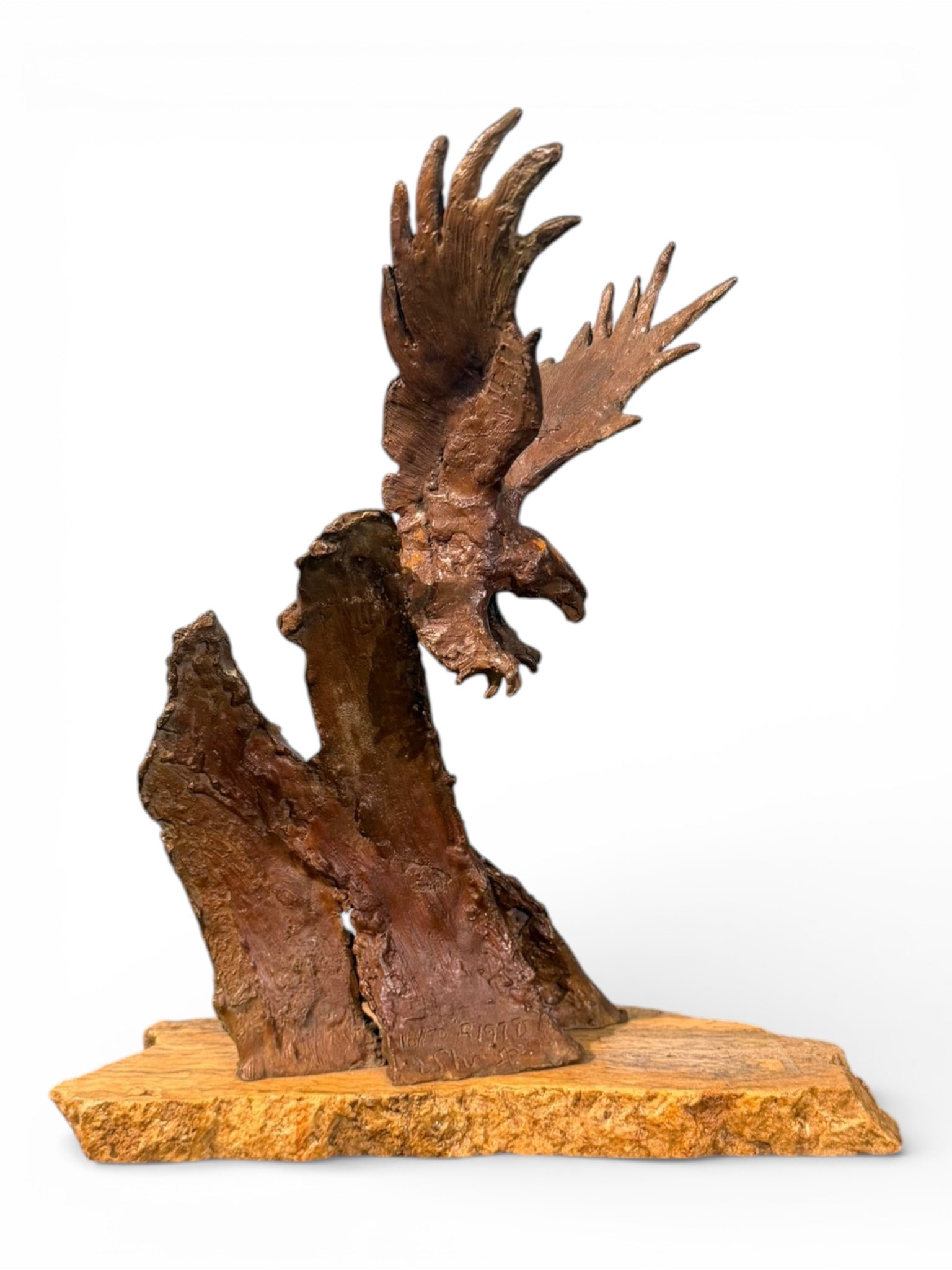 Limited Edition Bronze Eagle Sculpture: Limited Edition Bronze Eagle Sculpture, dated 1970, depicting an eagle in descent with wings spread, mounted on a textured naturalistic base over a simulated stone plinth; inscribed “18/50 ©