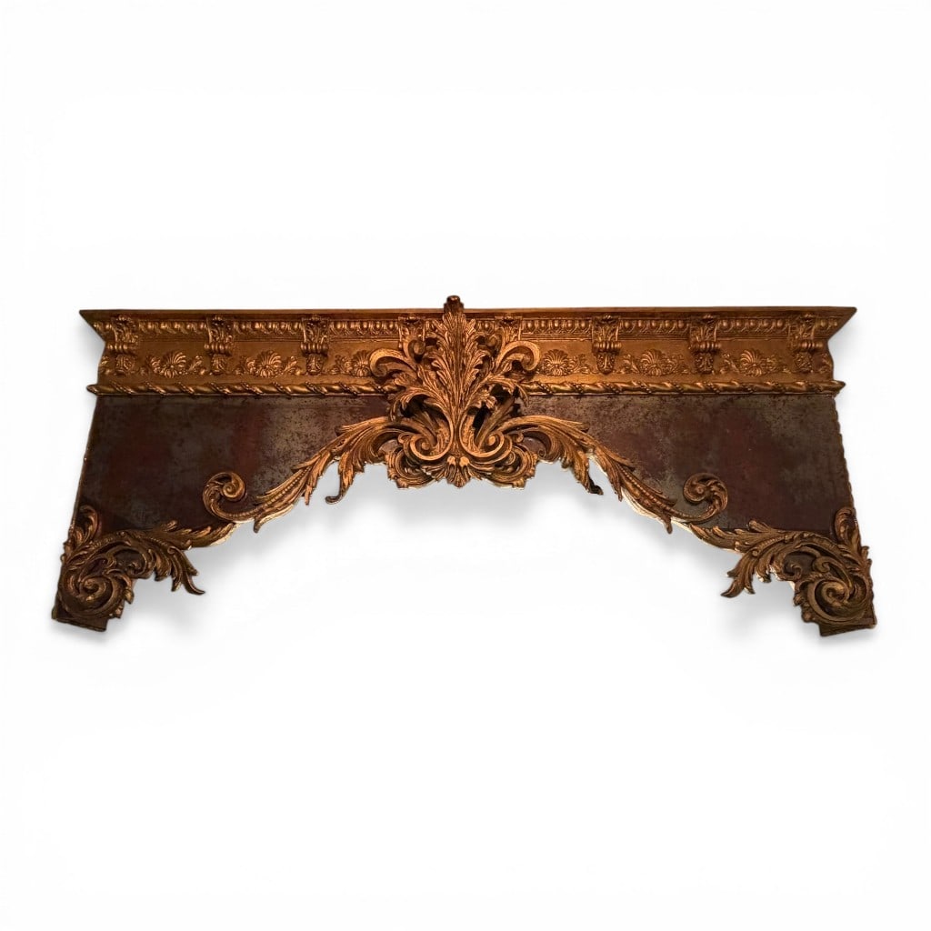 Pair of French Style Giltwood and Distressed Mirror Valence: Pair of ornate French style window valences or overmantel element, richly decorated with scrolling acanthus, foliate carving, and a prominent central cartouche crest. The composition is set against a