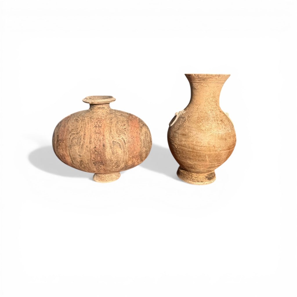 Pair of Chinese Pottery Vessels, Han Dynasty (206 B.C.–220 A.D.): A compelling pair of Chinese earthenware vessels attributed to the Han dynasty, comprising a baluster-form vase with flared neck and applied ring handles, and a compressed globular jar with short