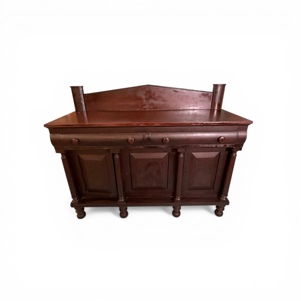American Empire Mahogany Sideboard: American Empire period mahogany sideboard, mid-19th century, of substantial rectangular form with shaped backsplash flanked by turned columnar supports, above a case fitted with a long frieze drawer