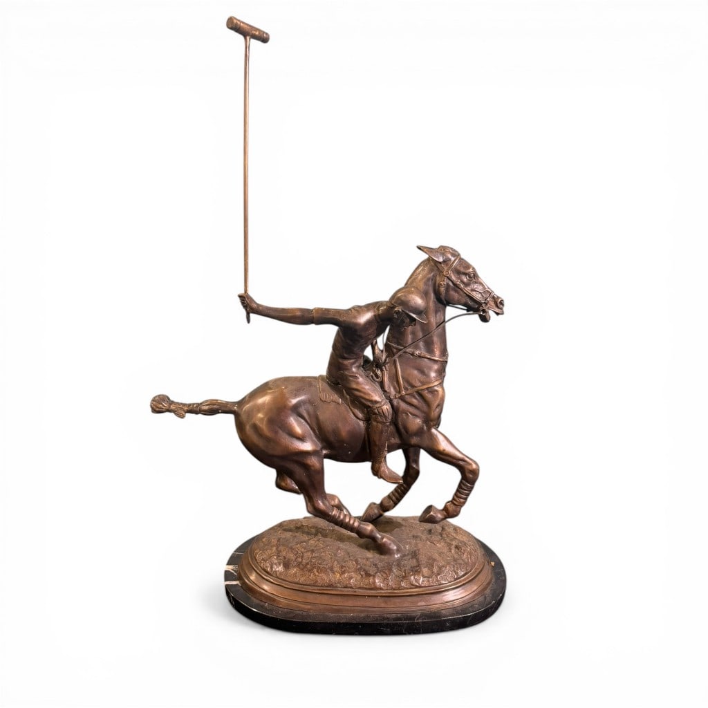 Bronze Sculpture of Polo Player on Horseback: Dynamic bronze sculpture depicting a polo player in full swing atop a galloping horse, the rider dramatically extended with mallet raised, conveying motion and athletic tension. Well-modeled