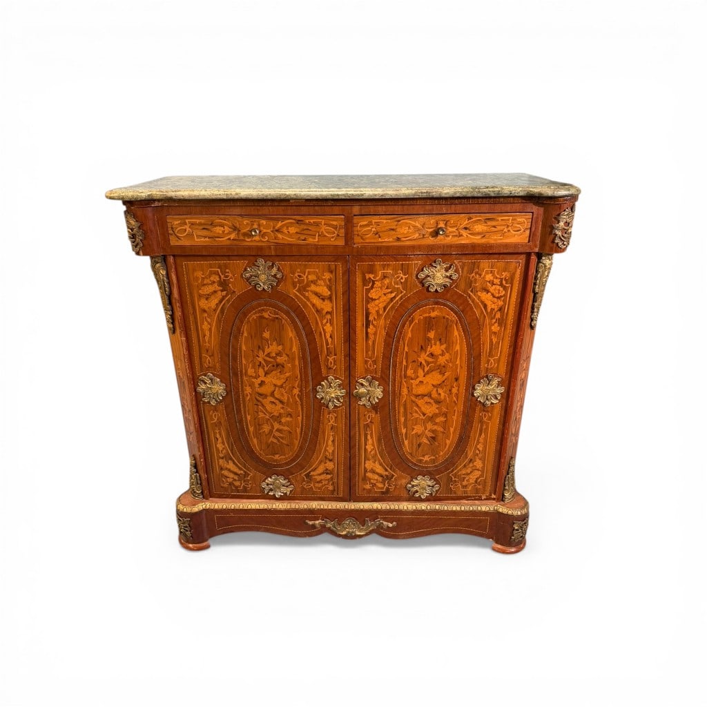 French Louis XV Style Marquetry Marble-Top Cabinet with Ormolu Mounts: A finely crafted French Louis XV style cabinet featuring an elegant serpentine-form case richly adorned with intricate floral marquetry throughout. The façade is centered by two paneled doors, each i