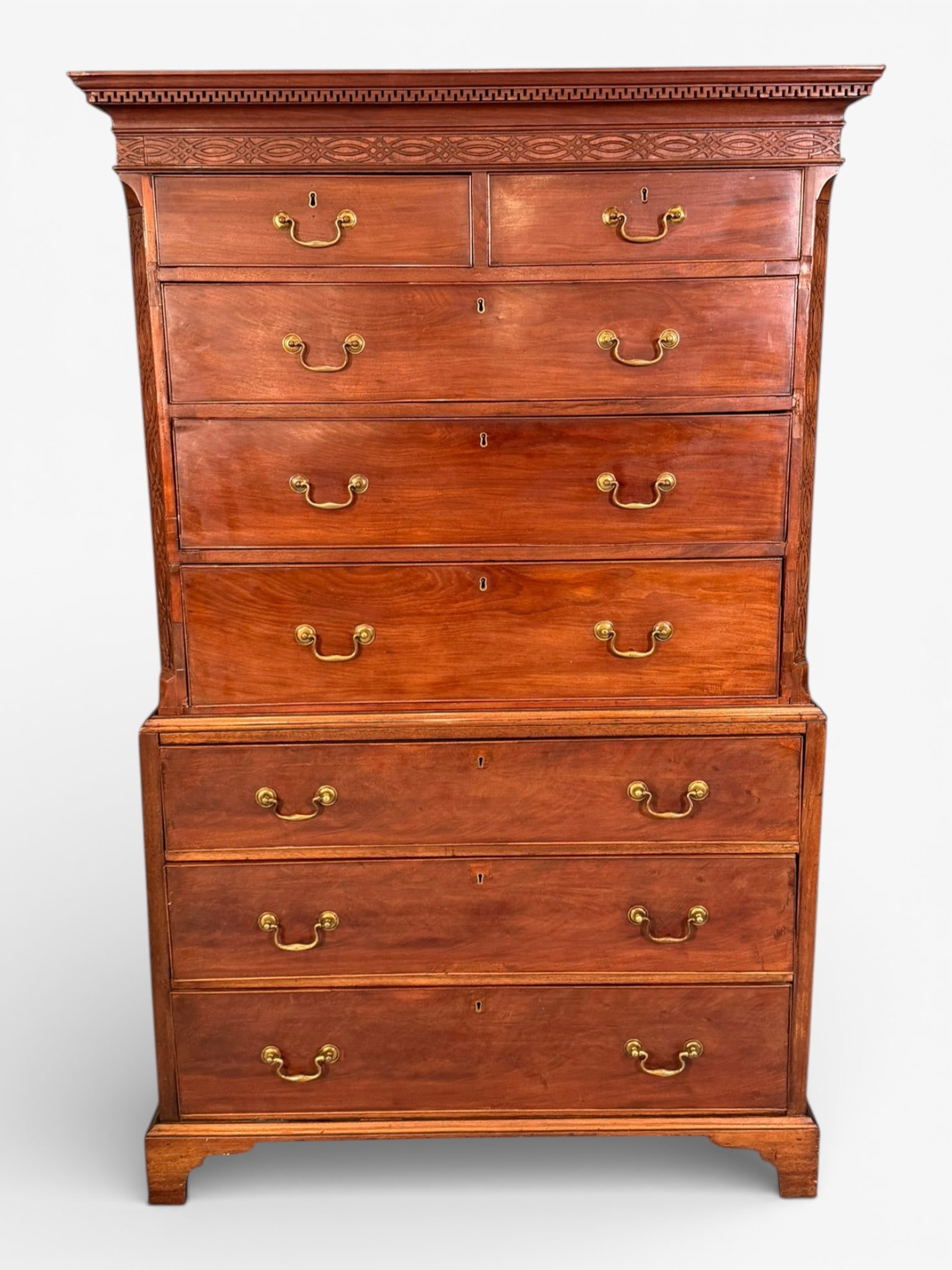 English Georgian-Style Mahogany Chest on Chest, late 18th, early 19th century: English Georgian-Style Mahogany Chest on Chest, late 18th to early 19th century, in two parts, the upper section with molded cornice above a carved frieze featuring repeating geometric and oval