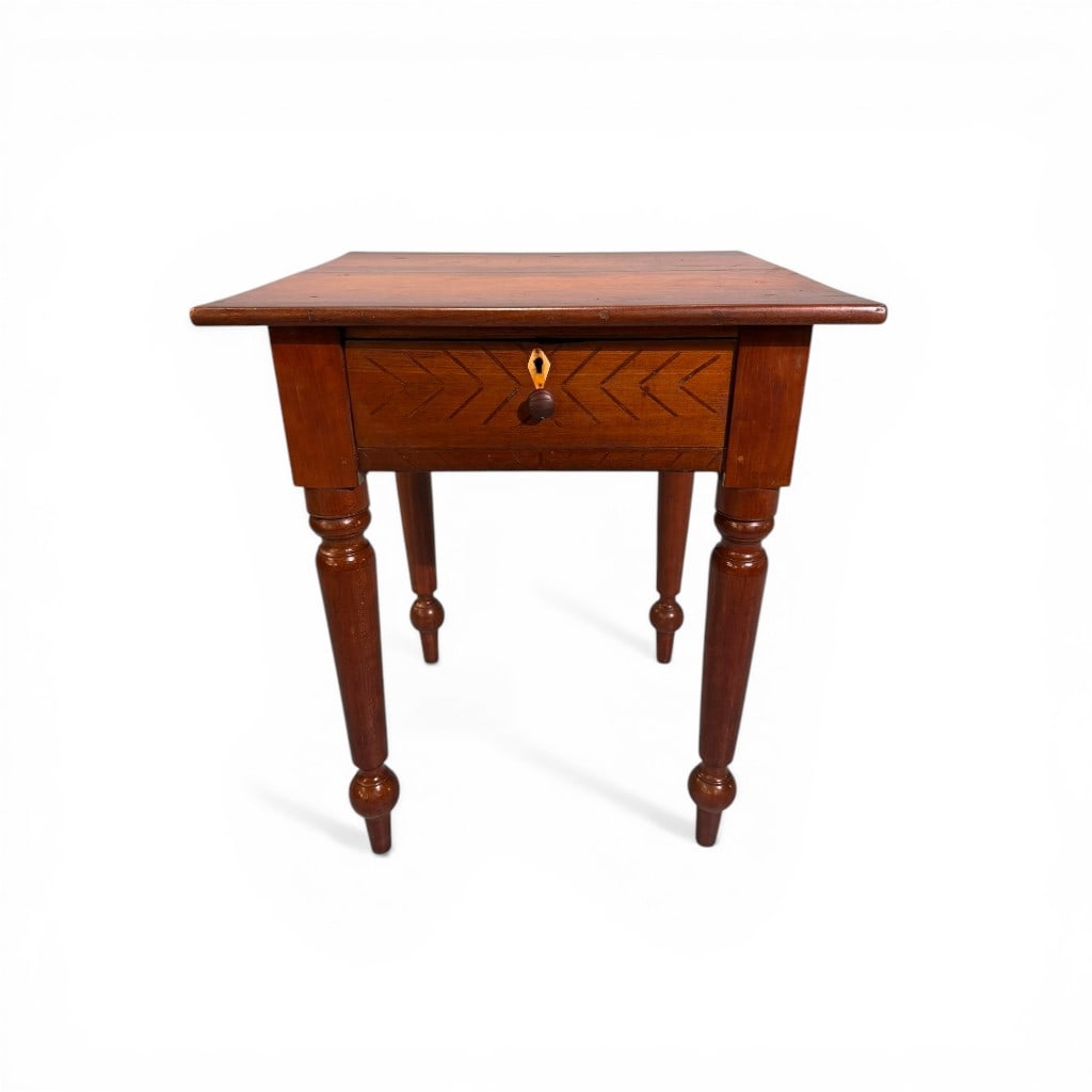 Southern American Cherry One-Drawer Work Table, mid-19th century: An American cherry work table of compact form, Southern in origin, featuring a rectangular top above a single dovetailed drawer with distinctive chip-carved geometric decoration. The drawer retains