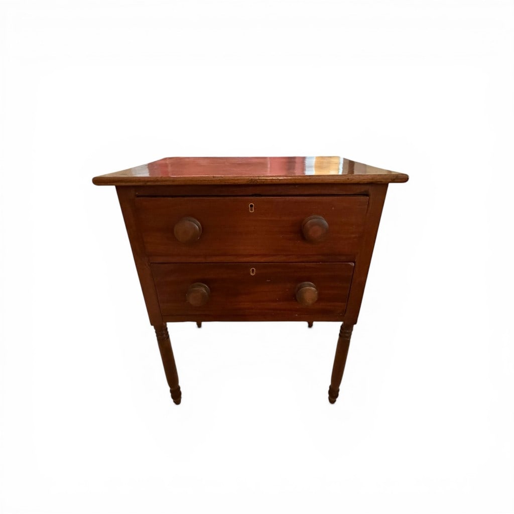 American Cherry Two-Drawer Stand, Southern, mid-19th century: American two-drawer stand in cherry, likely Southern in origin, featuring a rectangular top above two graduated drawers fitted with simple turned wooden knobs and original key escutcheons. The case