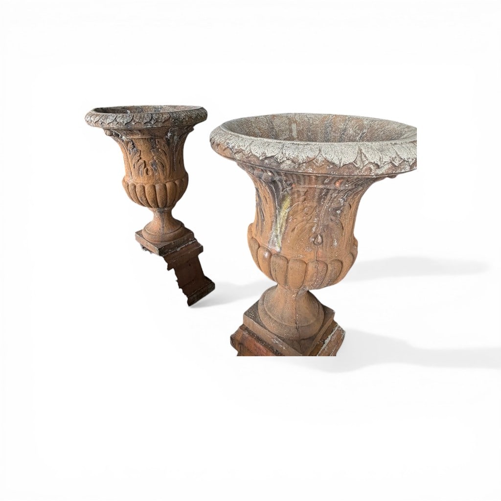 Pair of Monumental Terracotta Garden Urns on Pedestals: A substantial pair of monumental terracotta garden urns of classical campana form, each raised on a square pedestal base. The urns feature a broad, flared rim with scalloped edging above a deeply
