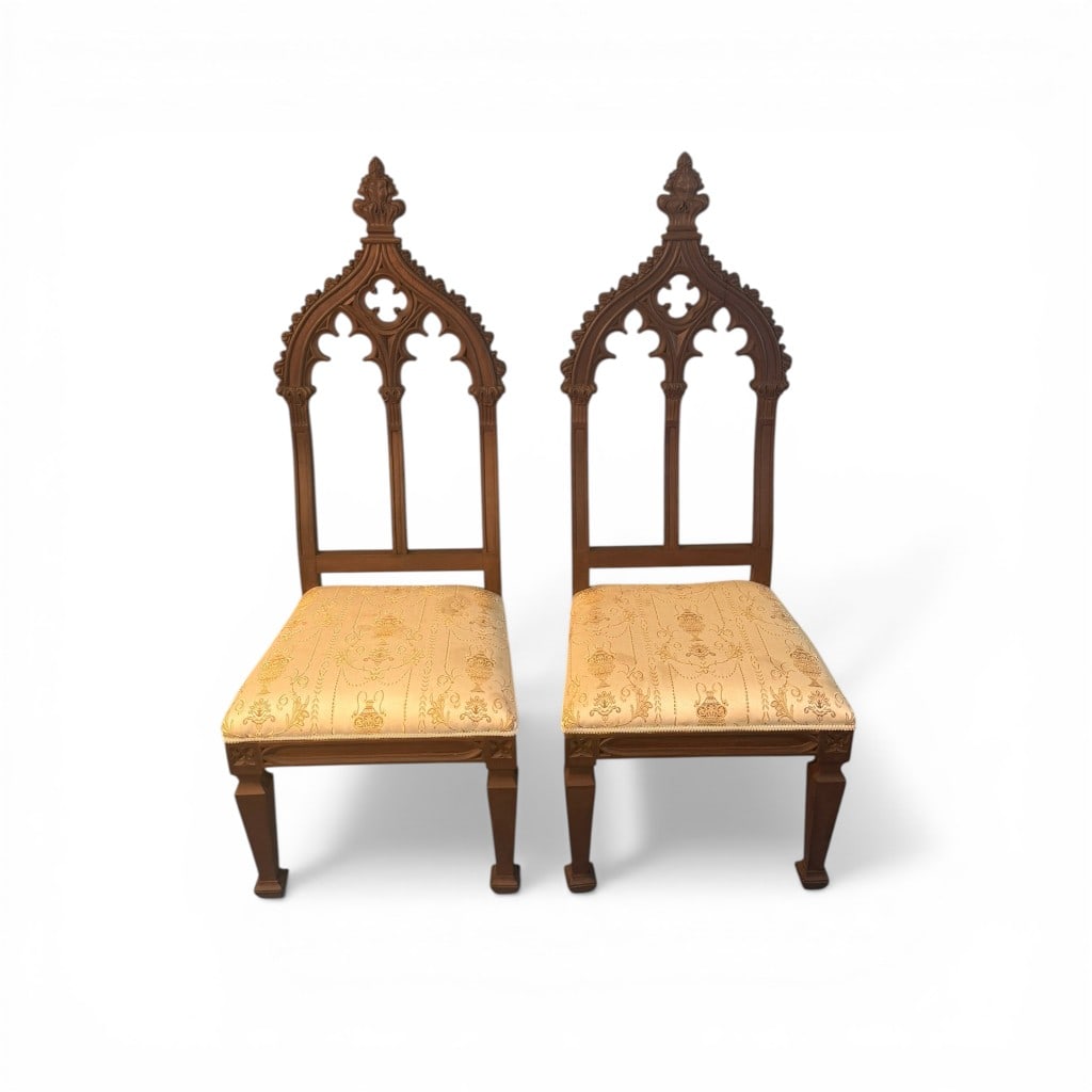 Pair of Gothic Revival Style Side Chairs: Pair of Gothic Revival style side chairs, likely late 19th to early 20th century, crafted in warm-toned walnut. Each chair features a tall, architectural back with pointed arch cresting, pierced
