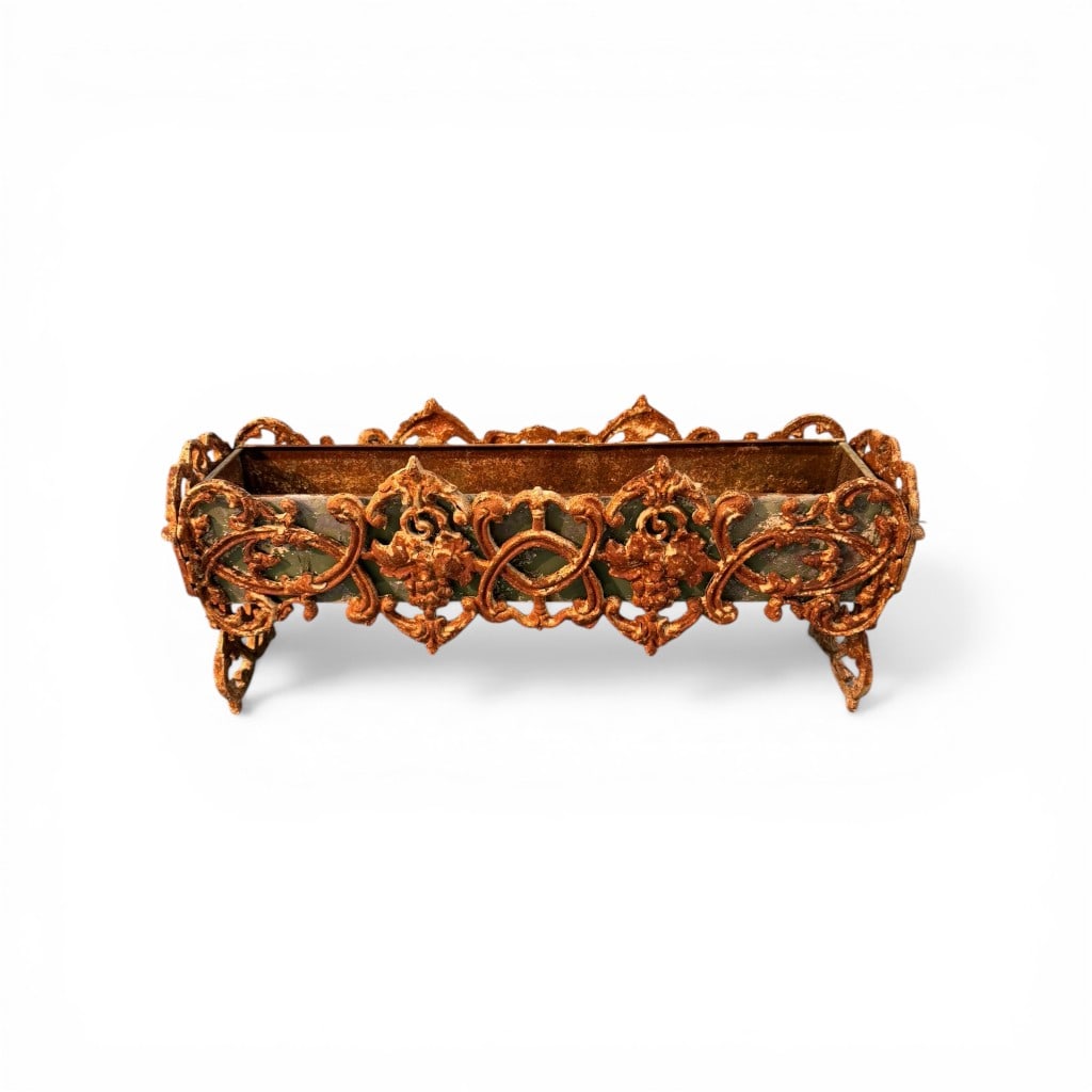 Cast Iron Garden Planter with Figural and Foliate Decoration: A highly decorative cast iron garden planter of elongated rectangular form, featuring an ornate openwork surround with scrolling foliate motifs, grape clusters, and classical-inspired ornamentation.