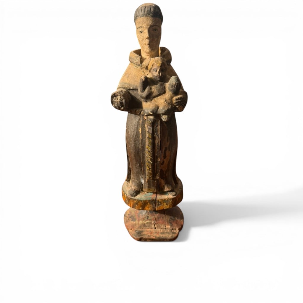 Spanish Colonial Carved and Polychromed Santos Figure of a Saint, Attr. to St. Francis de Sales: A compelling Spanish Colonial carved and polychromed wooden santos figure depicting a standing saint holding the Christ Child, likely representing St. Francis de Sales as suggested by the partially