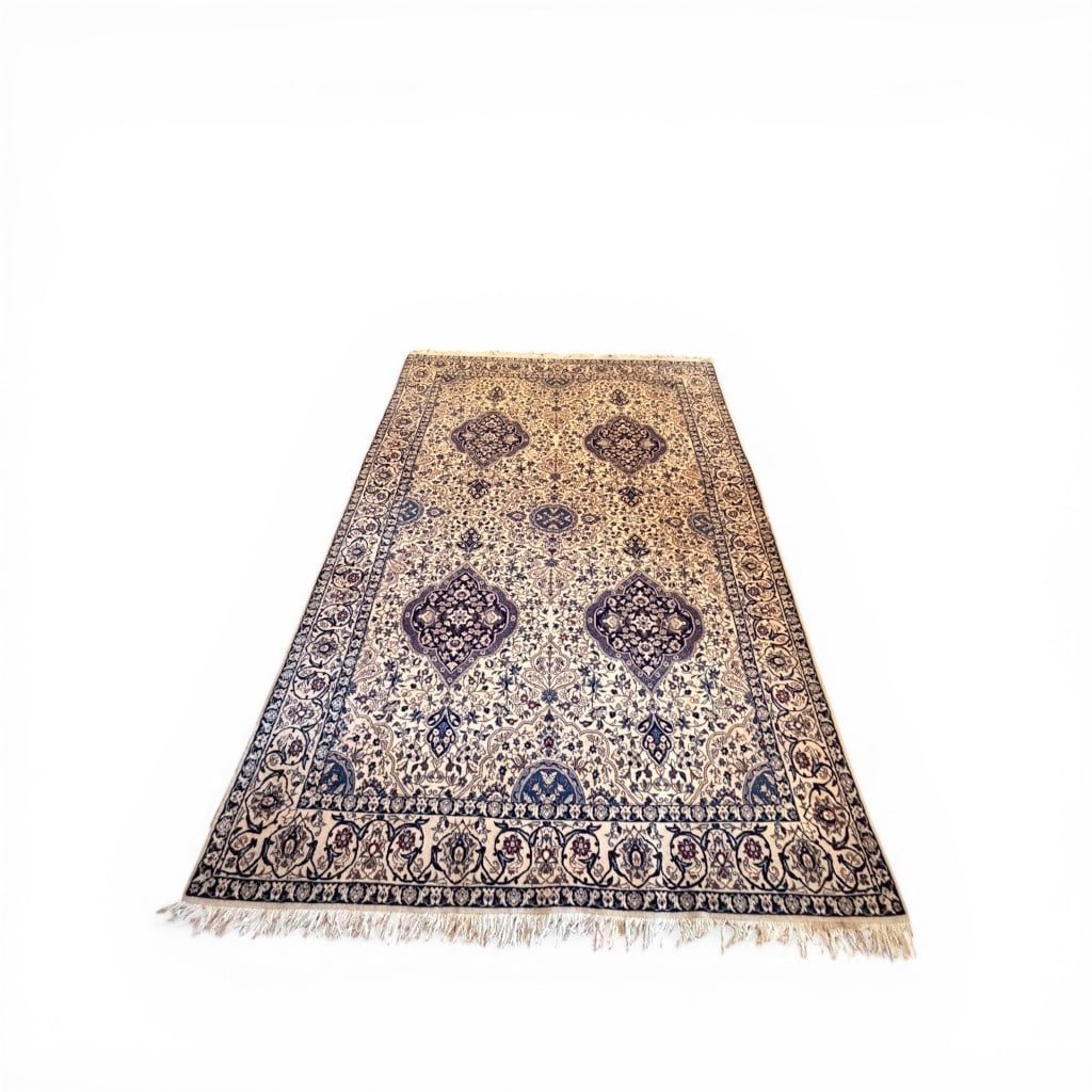 Persian Handwoven Nain Carpet: A finely woven Persian Nain carpet featuring an elegant ivory field richly decorated with scrolling floral arabesques and repeating lobed medallions in deep navy and soft blue tones. The composition i