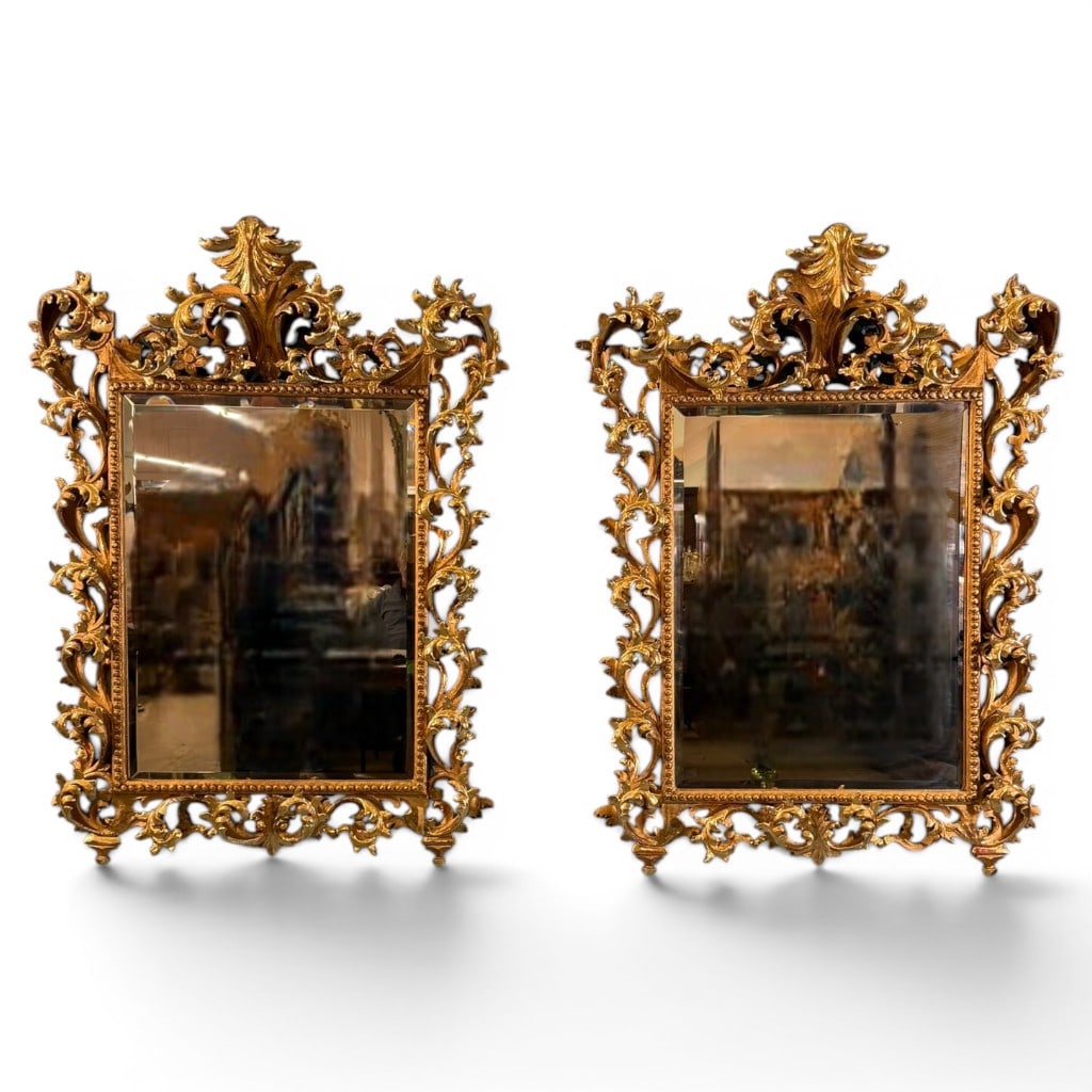Pair of Italian Rococo Revival Giltwood Mirrors, Late 19th/Early 20th Century: Pair of ornate Italian or Continental Rococo Revival giltwood mirrors, late 19th to early 20th century, each with rectangular beveled mirror plate within a beaded inner frame and exuberantly pierced