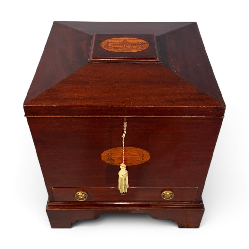 Regency Mahogany Inlaid Cellarette, Early 19th Century: A handsome early 19th century Regency mahogany cellarette, British, circa 1800?1820, of square sarcophagus form with a deeply sloped and molded hinged lid, raised center panel, and oval