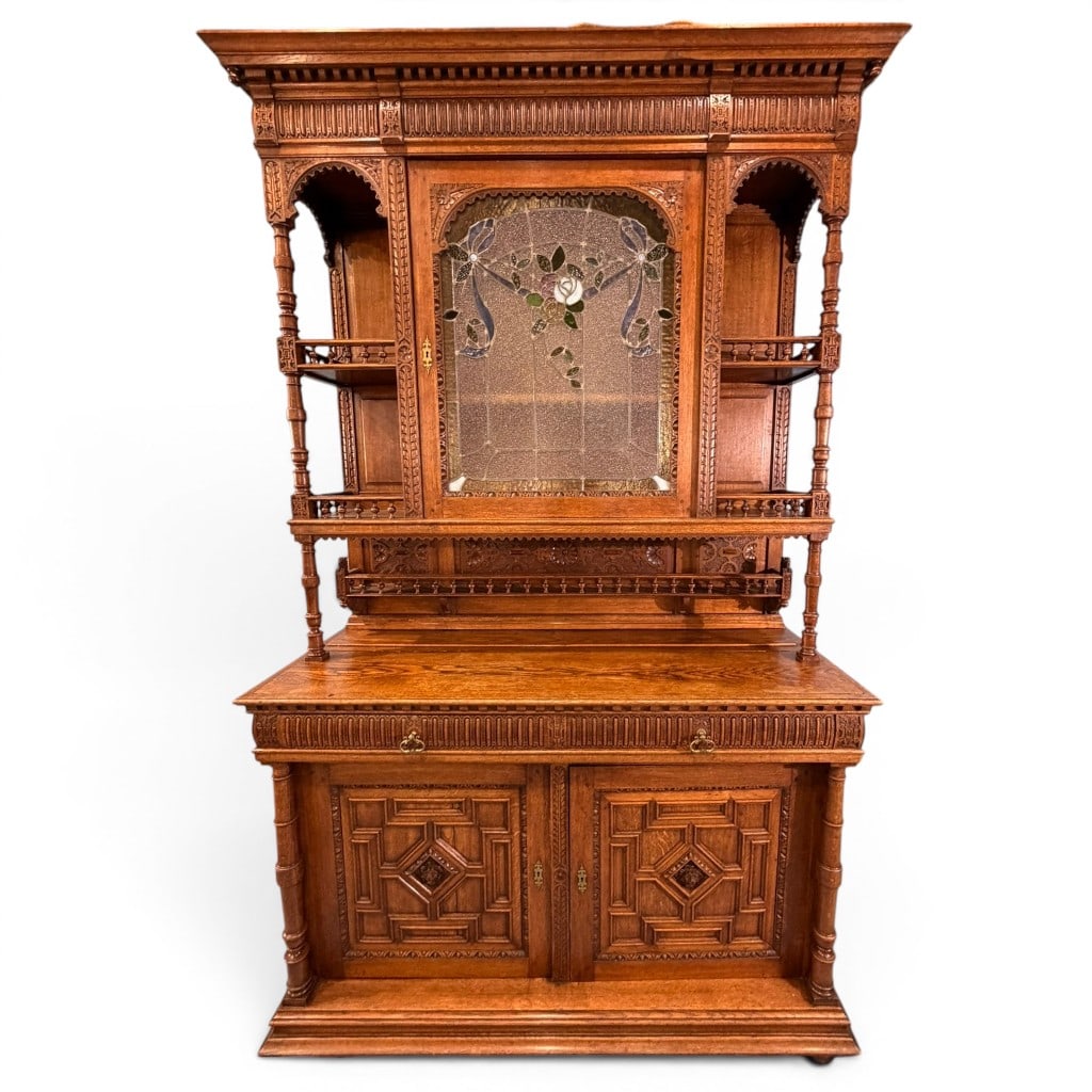 Large Victorian Renaissance Revival Carved Oak Sideboard Cabinet, Leaded Stained Glass Door: Victorian Renaissance Revival carved oak sideboard cabinet, late 19th century, of highly architectural form with a projecting molded cornice above a carved dentil and gadrooned frieze. The upper