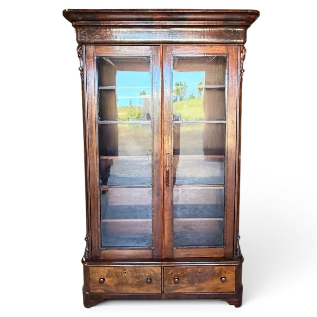 American Empire Rosewood and Mahogany Bookcase: American Empire bookcase, mid-19th century, in mahogany with rosewood or highly figured rosewood-grained veneers, having a bold molded cornice above two glazed doors opening to adjustable shelves,