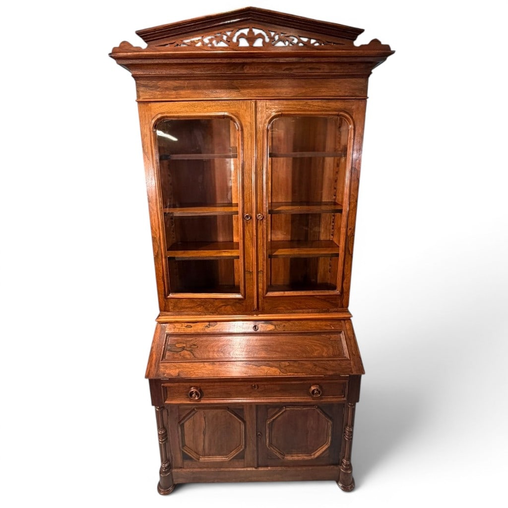 Victorian Rosewood Secretary Bookcase: A fine Victorian rosewood secretary bookcase, late 19th century, of tall architectural form with richly figured rosewood surface and a pierced carved pediment crest. The upper section has a projecting