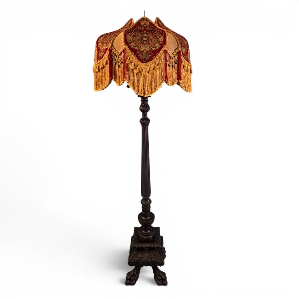 Acanthus Carved Brothel Floor Lamp: Ornate carved floor lamp in the Victorian/Renaissance Revival taste, having a dark finished carved standard with fluted column, turned bulbous supports, acanthus-carved square base, and paw-form feet.