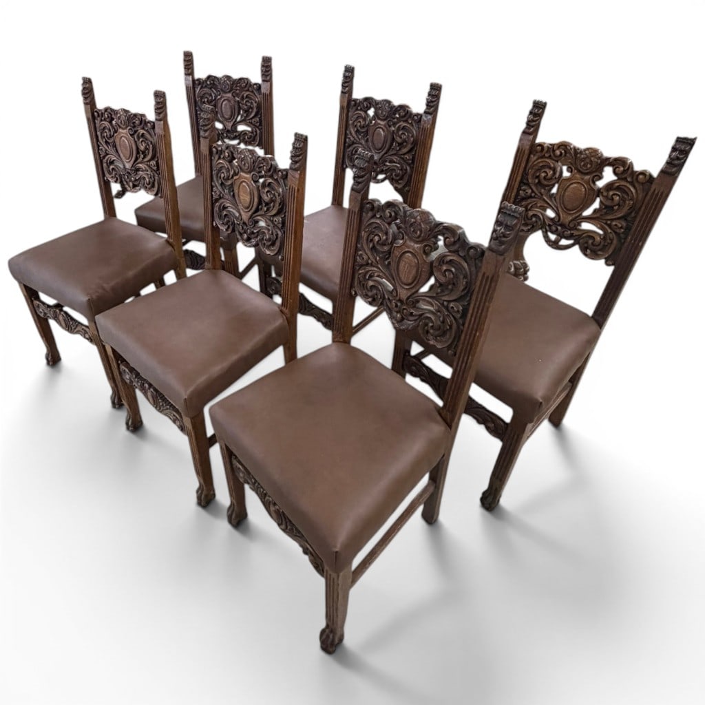 Set of Six Carved Oak Renaissance Revival Dining Chairs, Attr. to R.J. Horner: A set of six carved oak Renaissance Revival dining chairs, late 19th century, formerly part of a larger carved oak dining suite. Each chair features a highly pierced and carved crest with scrolling