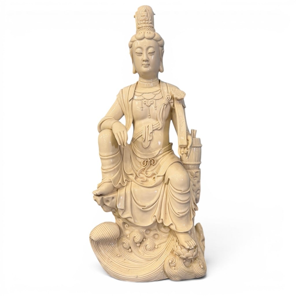 Large Chinese Blanc de Chine Guanyin Figure, Dehua, 19th C.: Large Chinese Blanc de Chine / Dehua porcelain figure of Guanyin, 19th century, modeled seated upon a rockwork and wave-form base, the bodhisattva shown in flowing robes with elaborate jewelry, high c