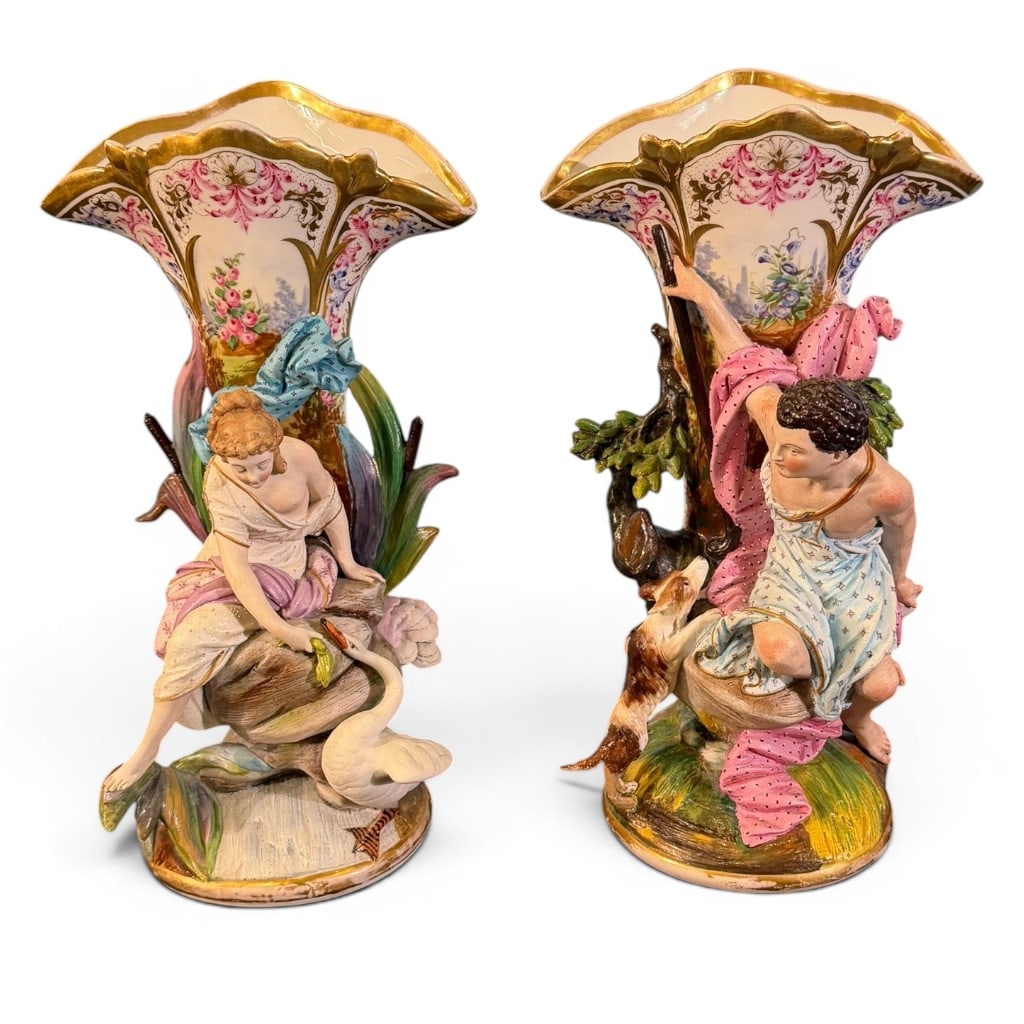 Pair Old Paris Figural Porcelain Vases: Pair of Old Paris figural porcelain vases, 19th century, each with flared shaped rim, gilt highlights, floral panels, and applied figural decoration. One vase depicts a seated maiden with swan beside