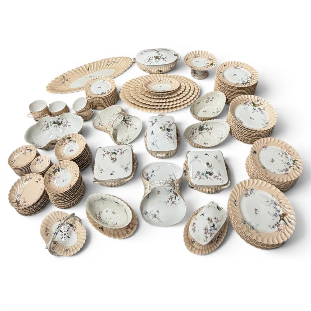 Large 147-Piece Porcelain Dinner Service: Large 147-piece porcelain dinner service, decorated with floral sprays, birds, insects, and molded shell-form borders in soft cream and white ground, comprising 23 dinner plates, 11 salad plates, 12