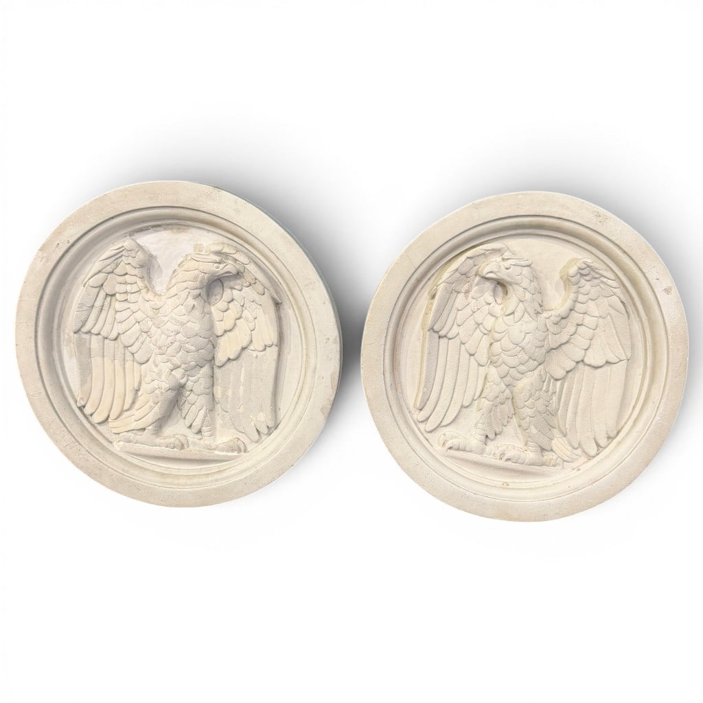 Pair of Neoclassical Eagle Bas-Relief Medallions: Pair of circular cast plaster or composition bas-relief medallions, each depicting a spread-wing eagle within molded circular border, fitted with hanging hardware verso. White painted or plaster