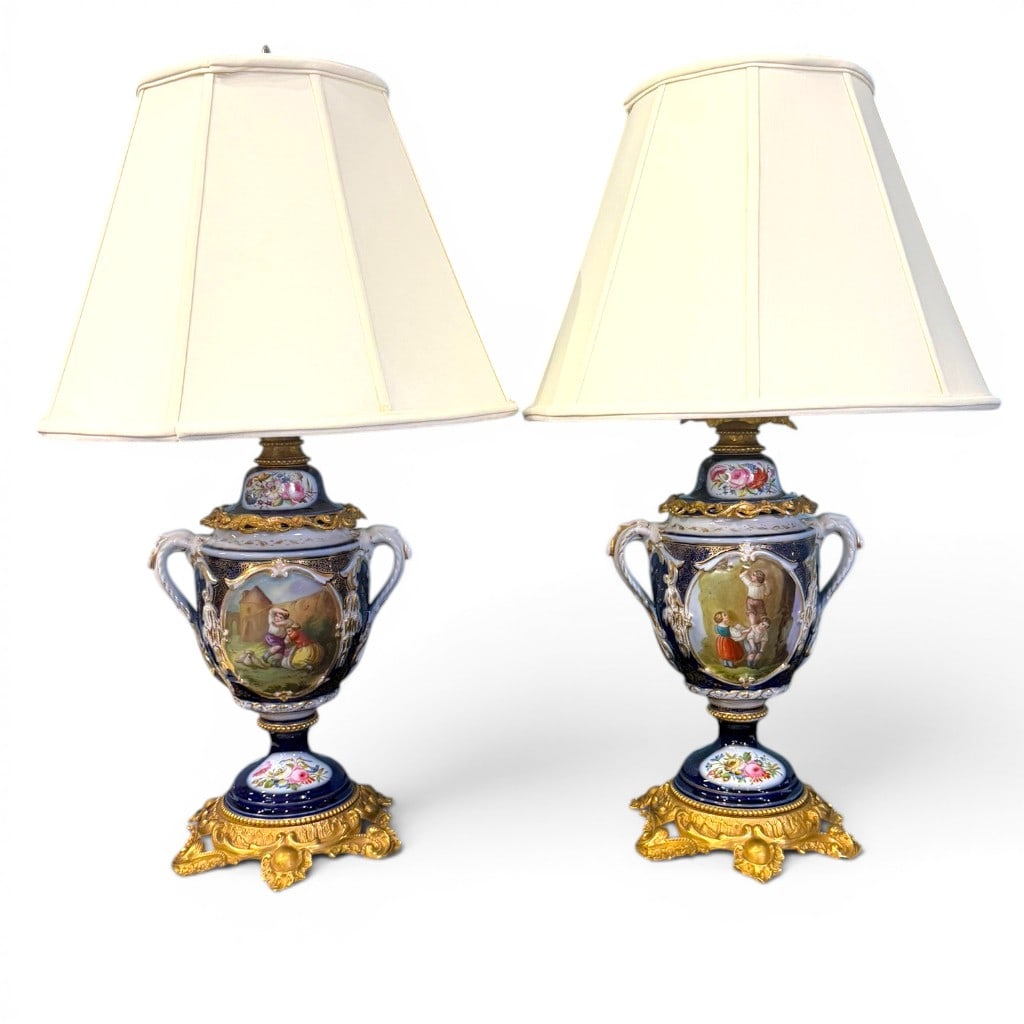 Pair of Paris Porcelain Urn-Form Table Lamps: Pair of Paris porcelain urn-form table lamps, the porcelain bodies in cobalt blue, white, and gilt decoration with hand-painted figural reserves of children in pastoral landscapes, floral-painted