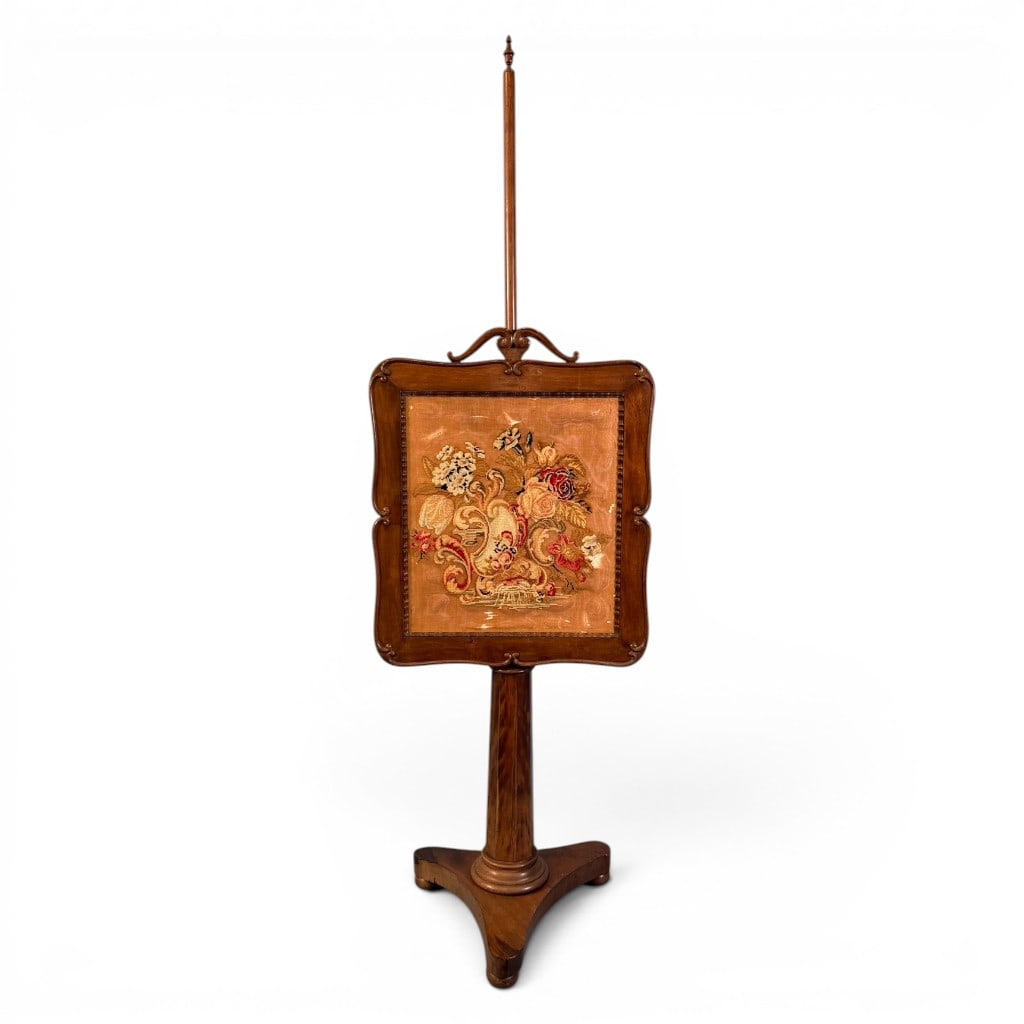Victorian Walnut Needlepoint Pole Firescreen: Victorian walnut pole firescreen, late 19th century, having a shaped carved walnut frame enclosing a floral needlepoint panel under glass. The needlework depicts a large bouquet of roses, lilies, and