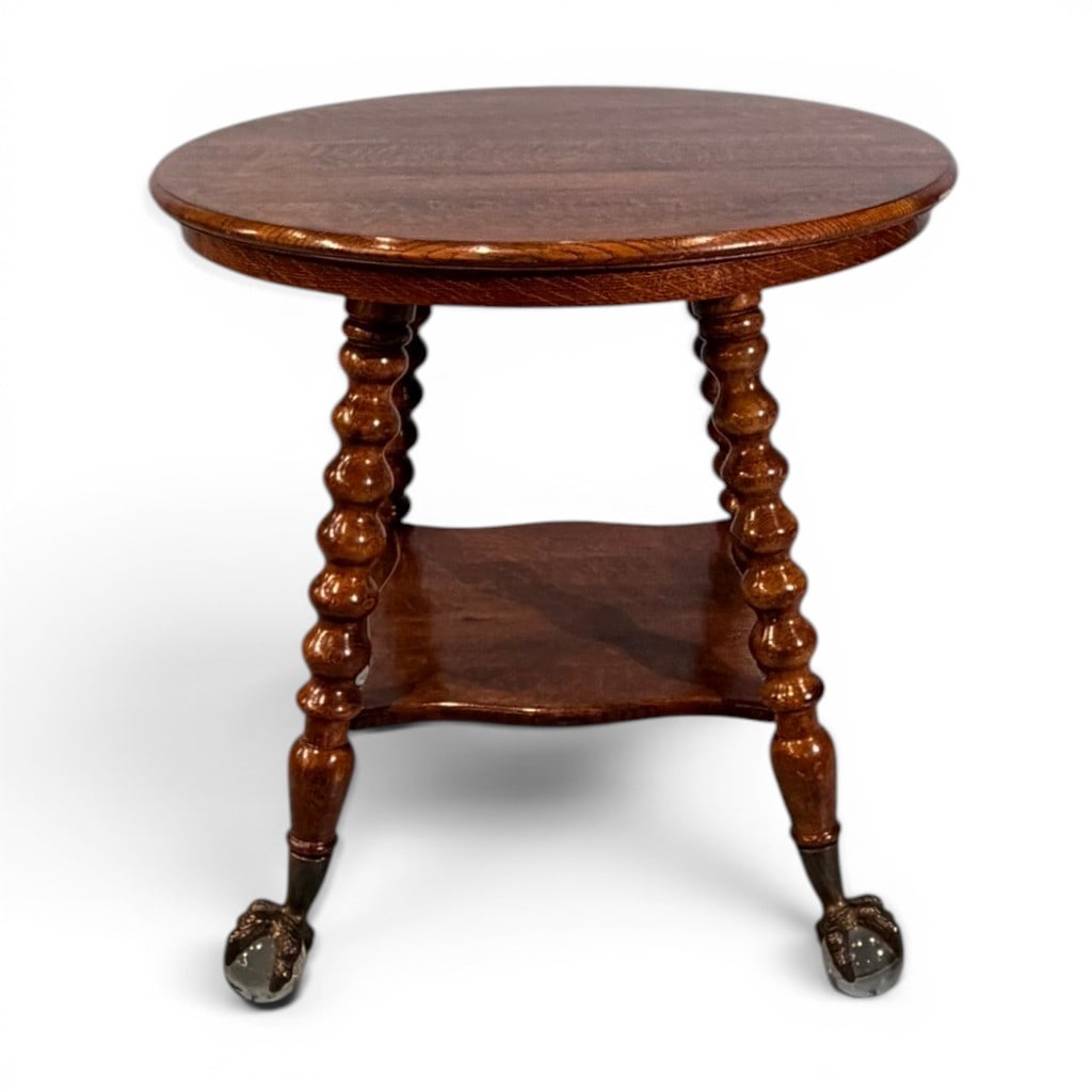 Oak Round Center Table with Barley-Twist Supports and Ball-and-Claw Feet: Round oak center or parlor table, late 19th to early 20th century, the circular top with molded edge raised on four turned barley-twist supports joined by a shaped lower shelf, terminating in